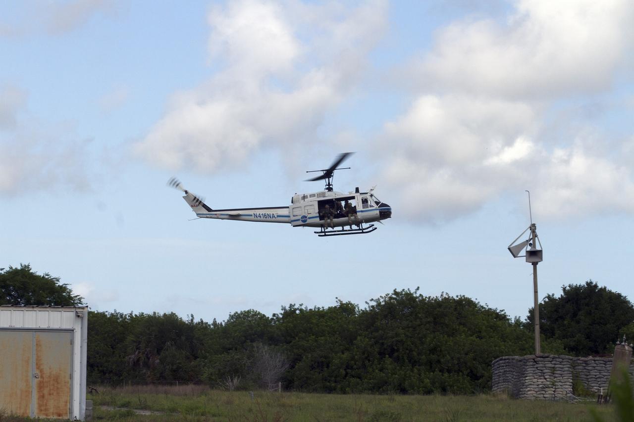 CAPE CANAVERAL, Fla. – CAPE CANAVERAL, Fla. – Emergency Response Team officers from the Protective Services branch of NASA's Kennedy Space Center in Florida prepare to descend from a Huey helicopter from the Aircraft Operations branch during a training exercise. The flight was the beginning of a training mission to simulate a situation the team and pilots could confront at the center. Photo credit: NASA/Dan Casper