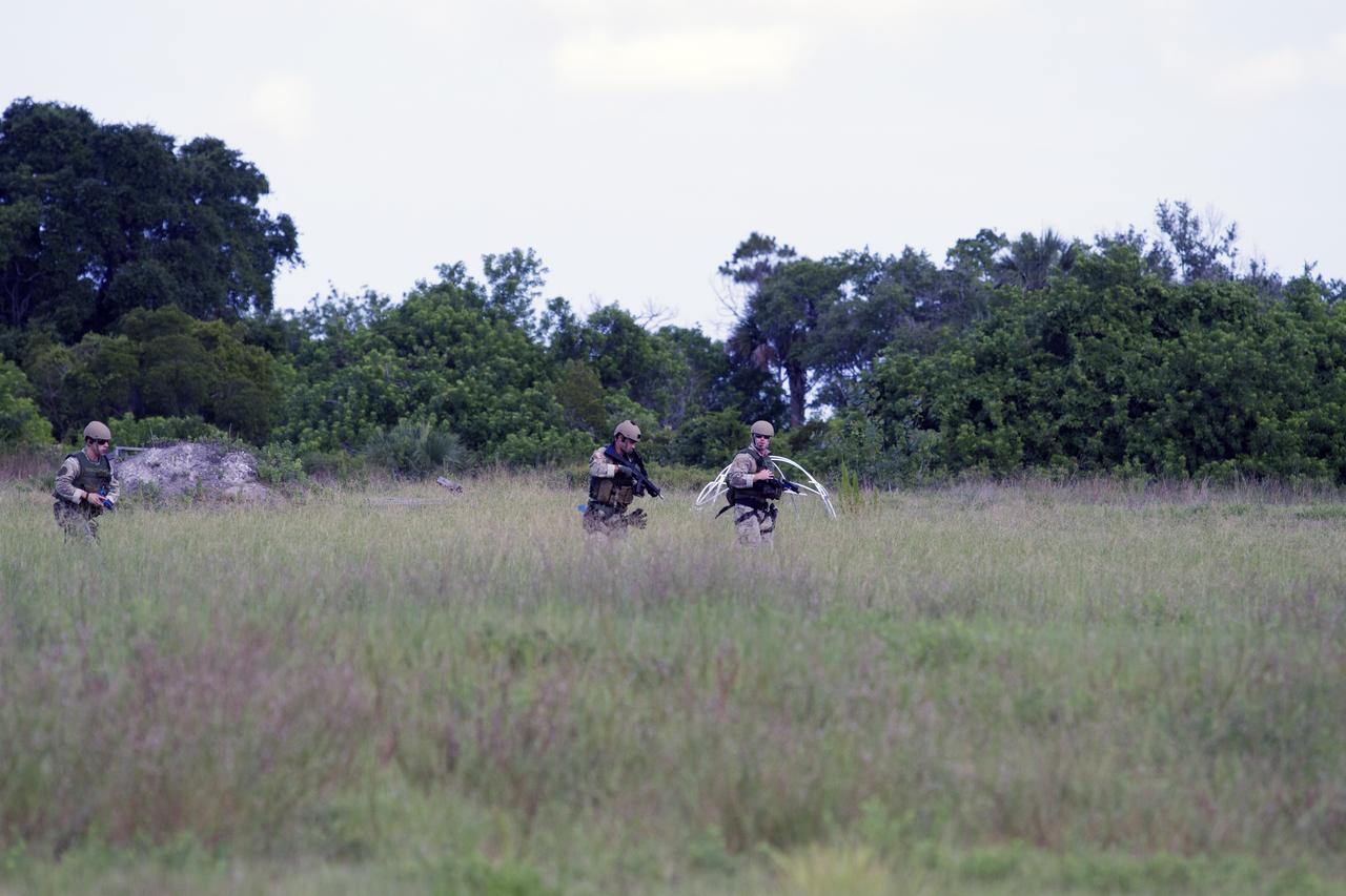 CAPE CANAVERAL, Fla. – Emergency Response Team officers from the Protective Services branch of NASA's Kennedy Space Center in Florida move through a field on their way to an objective during a training exercise simulating a situation the team could confront at the center. Photo credit: NASA/Dan Casper