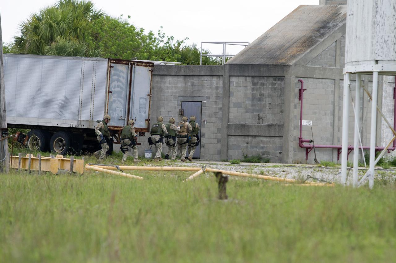 CAPE CANAVERAL, Fla. – Emergency Response Team officers from the Protective Services branch of NASA's Kennedy Space Center in Florida prepare to enter an objective during a training exercise simulating a situation the team could confront at the center. Photo credit: NASA/Dan Casper