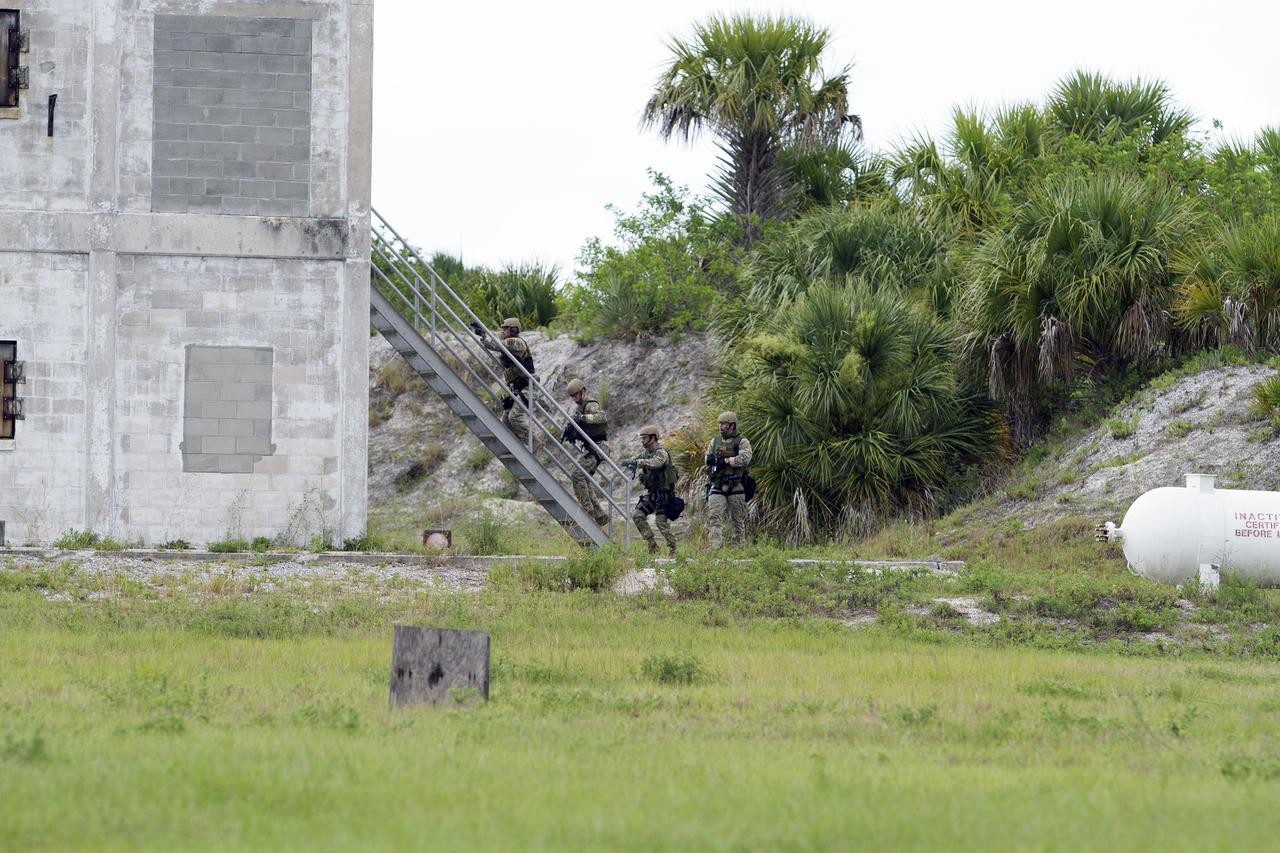 CAPE CANAVERAL, Fla. – Emergency Response Team officers from the Protective Services branch of NASA's Kennedy Space Center in Florida enter an objective during a training exercise simulating a situation the team could confront at the center. Photo credit: NASA/Dan Casper