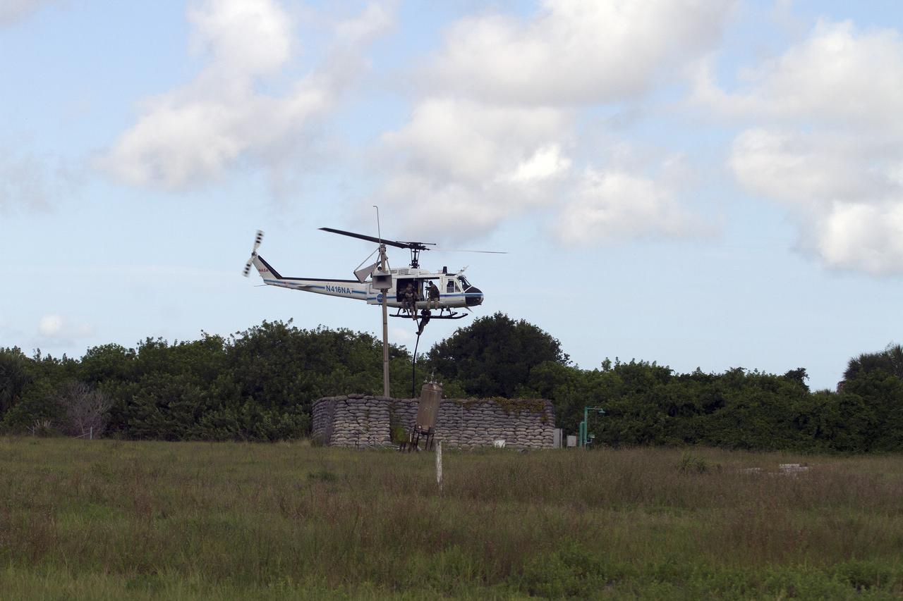 CAPE CANAVERAL, Fla. – Emergency Response Team officers from the Protective Services branch of NASA's Kennedy Space Center in Florida descend from a Huey helicopter from the Aircraft Operations branch during a training exercise. The flight was the beginning of a training mission to simulate a situation the team and pilots could confront at the center. Photo credit: NASA/Dan Casper