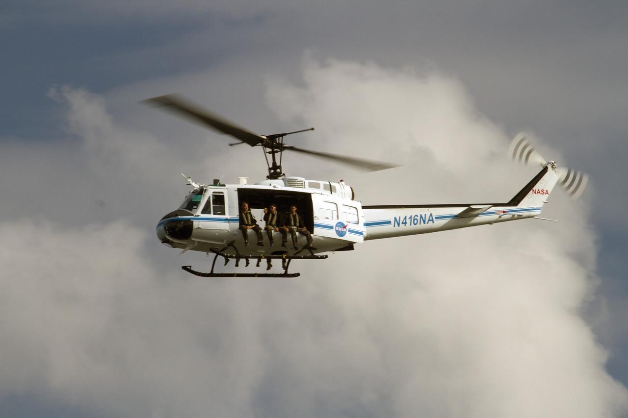 CAPE CANAVERAL, Fla. – A Huey helicopter from the Aircraft Operations branch at NASA's Kennedy Space Center in Florida flies over the Indian River Lagoon with a group of Emergency Response Team officers from the center's Protective Services branch during a training exercise. The training session focused on safely entering the water, something the ERT could be required to perform in certain situations at the center. Photo credit: NASA/ Dan Casper