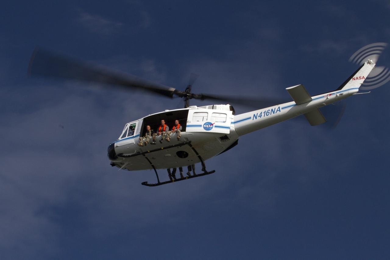 CAPE CANAVERAL, Fla. – A Huey helicopter from the Aircraft Operations branch at NASA's Kennedy Space Center in Florida flies over the Indian River Lagoon with a group of Emergency Response Team officers from the center's Protective Services branch during a training exercise. The training session focused on safely entering the water, something the ERT could be required to perform in certain situations at the center. Photo credit: NASA/ Dan Casper