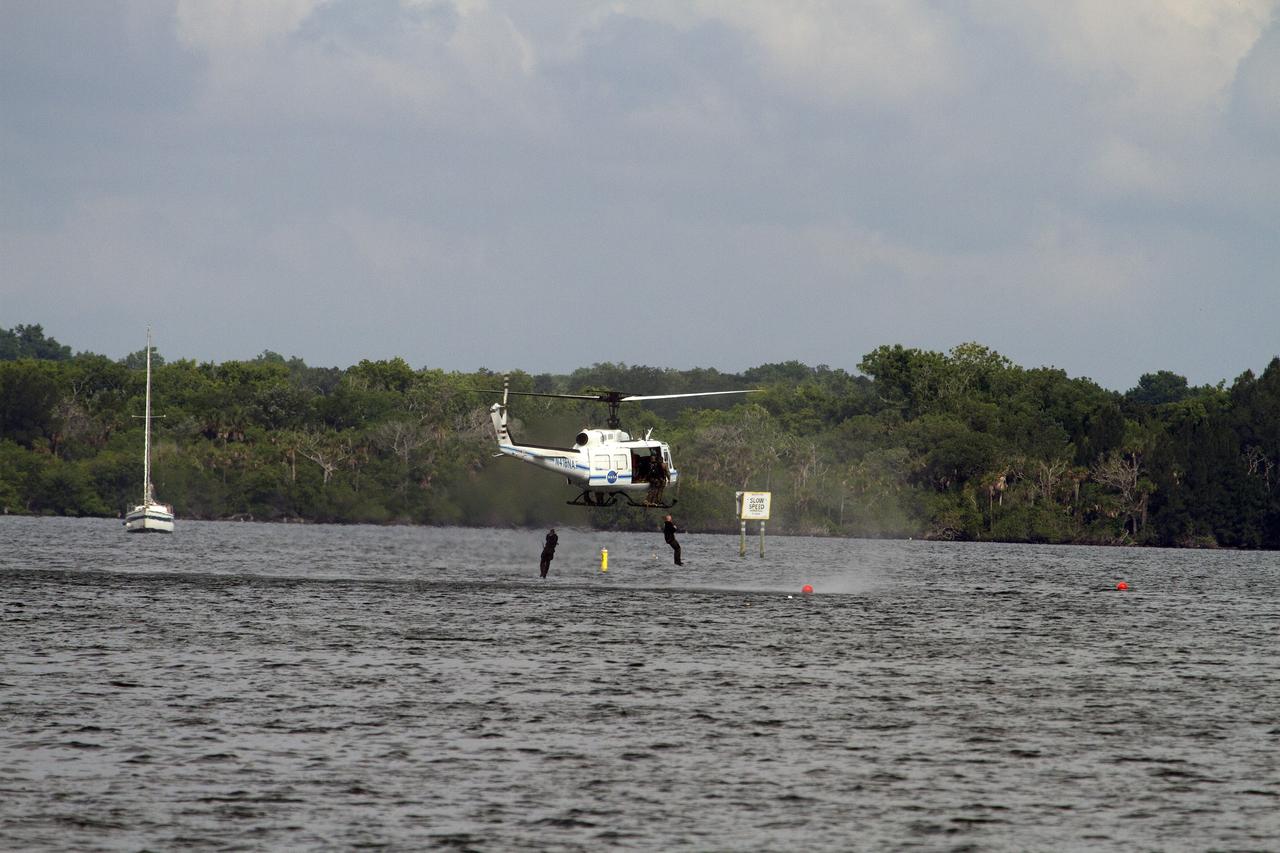 CAPE CANAVERAL, Fla. – Emergency Response Team officers from the Protective Services branch NASA's Kennedy Space Center in Florida enter the Indian River Lagoon from a Huey helicopter from the Aircraft Operations branch at the center during a training exercise. The training session focused on safely entering the water, something the ERT could be required to perform in certain situations at the center. Photo credit: NASA/ Dan Casper
