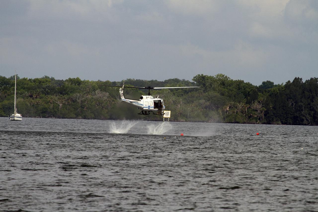 CAPE CANAVERAL, Fla. – Emergency Response Team officers from the Protective Services branch NASA's Kennedy Space Center in Florida enter the Indian River Lagoon from a Huey helicopter from the Aircraft Operations branch at the center during a training exercise. The training session focused on safely entering the water, something the ERT could be required to perform in certain situations at the center. Photo credit: NASA/ Dan Casper