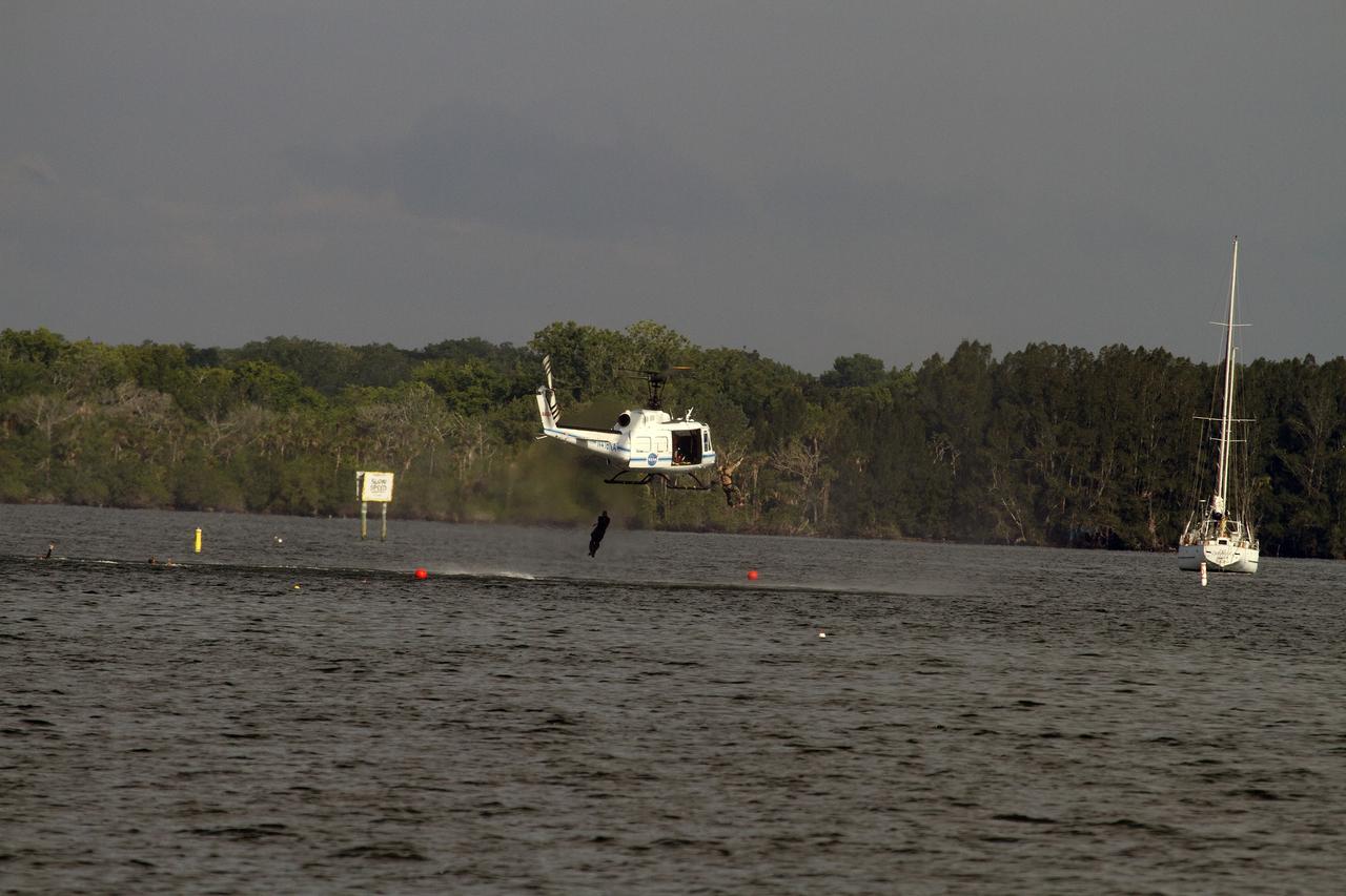 CAPE CANAVERAL, Fla. – Emergency Response Team officers from the Protective Services branch NASA's Kennedy Space Center in Florida enter the Indian River Lagoon from a Huey helicopter from the Aircraft Operations branch at the center during a training exercise. The training session focused on safely entering the water, something the ERT could be required to perform in certain situations at the center. Photo credit: NASA/ Dan Casper