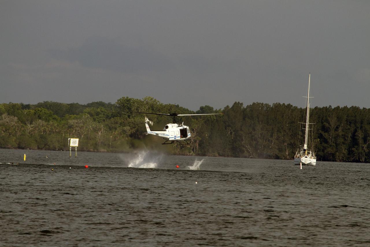 CAPE CANAVERAL, Fla. – Emergency Response Team officers from the Protective Services branch NASA's Kennedy Space Center in Florida enter the Indian River Lagoon from a Huey helicopter from the Aircraft Operations branch at the center during a training exercise. The training session focused on safely entering the water, something the ERT could be required to perform in certain situations at the center. Photo credit: NASA/ Dan Casper