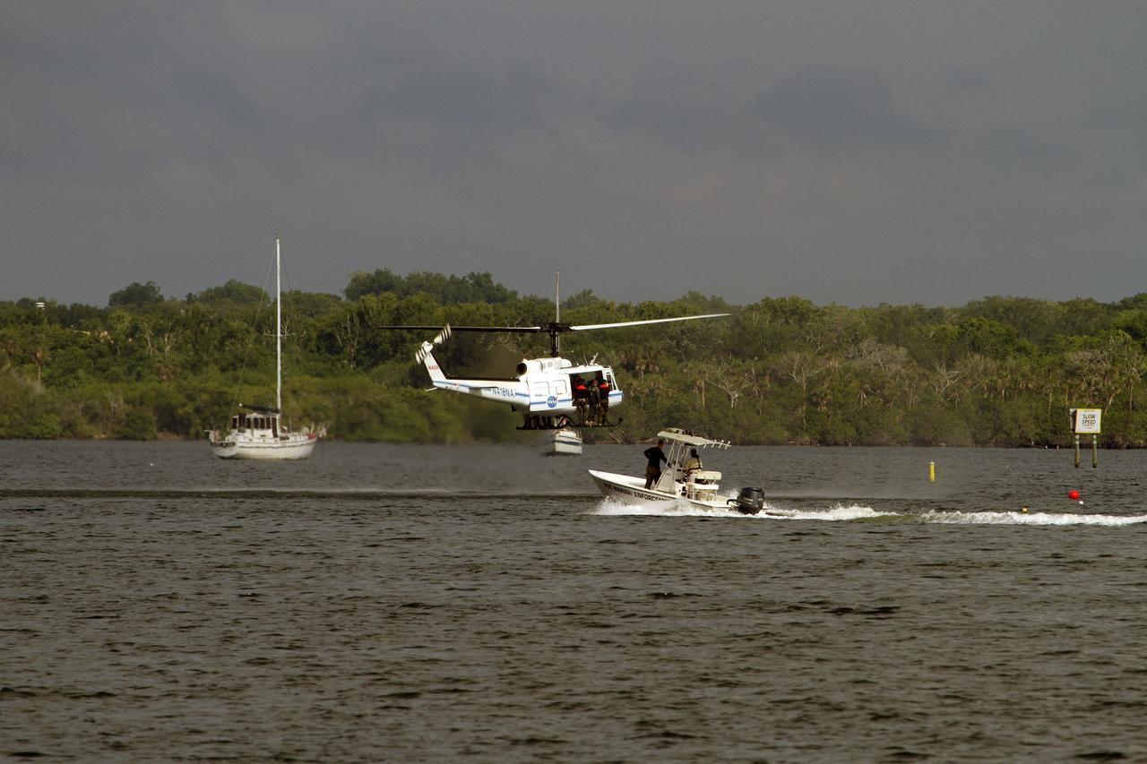 CAPE CANAVERAL, Fla. – Emergency Response Team officers from the Protective Services branch NASA's Kennedy Space Center in Florida prepare enter the Indian River Lagoon from a Huey helicopter from the Aircraft Operations branch at the center during a training exercise. The training session focused on safely entering the water, something the ERT could be required to perform in certain situations at the center. Photo credit: NASA/ Dan Casper