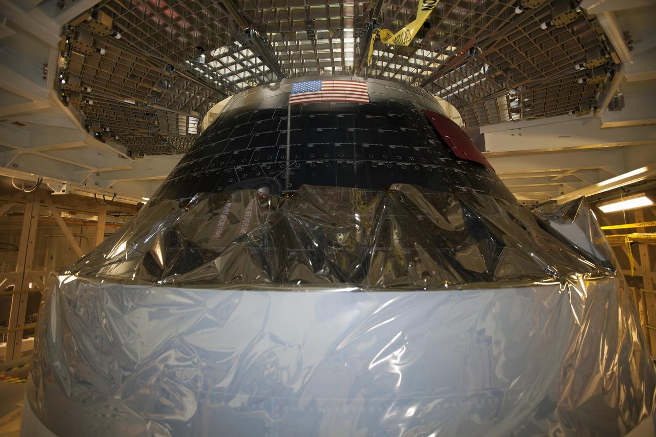 CAPE CANAVERAL, Fla. – Inside the Neil Armstrong Operations and Checkout Building high bay at NASA's Kennedy Space Center in Florida, preparations are underway to lift the Orion crew and service module stack for Exploration Flight Test-1 out of the test cell and transfer it to a mating device.    Orion is the exploration spacecraft designed to carry astronauts to destinations not yet explored by humans, including an asteroid and Mars. It will have emergency abort capability, sustain the crew during space travel and provide safe re-entry from deep space return velocities. The first unpiloted test flight of the Orion is scheduled to launch later this year atop a Delta IV Heavy rocket from Cape Canaveral Air Force Station in Florida to an altitude of 3,600 miles above the Earth's surface. The two-orbit, four-hour flight test will help engineers evaluate the systems critical to crew safety including the heat shield, parachute system and launch abort system. For more information, visit http://www.nasa.gov/orion. Photo credit: NASA/Ben Smegelsky