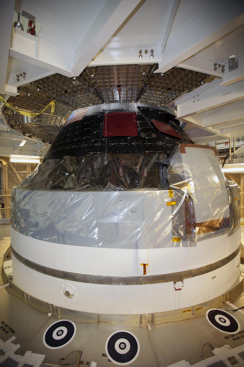 CAPE CANAVERAL, Fla. – Inside the Neil Armstrong Operations and Checkout Building high bay at NASA's Kennedy Space Center in Florida, preparations are underway to lift the Orion crew and service module stack for Exploration Flight Test-1 out of the test cell and transfer it to a mating device.    Orion is the exploration spacecraft designed to carry astronauts to destinations not yet explored by humans, including an asteroid and Mars. It will have emergency abort capability, sustain the crew during space travel and provide safe re-entry from deep space return velocities. The first unpiloted test flight of the Orion is scheduled to launch later this year atop a Delta IV Heavy rocket from Cape Canaveral Air Force Station in Florida to an altitude of 3,600 miles above the Earth's surface. The two-orbit, four-hour flight test will help engineers evaluate the systems critical to crew safety including the heat shield, parachute system and launch abort system. For more information, visit http://www.nasa.gov/orion. Photo credit: NASA/Ben Smegelsky