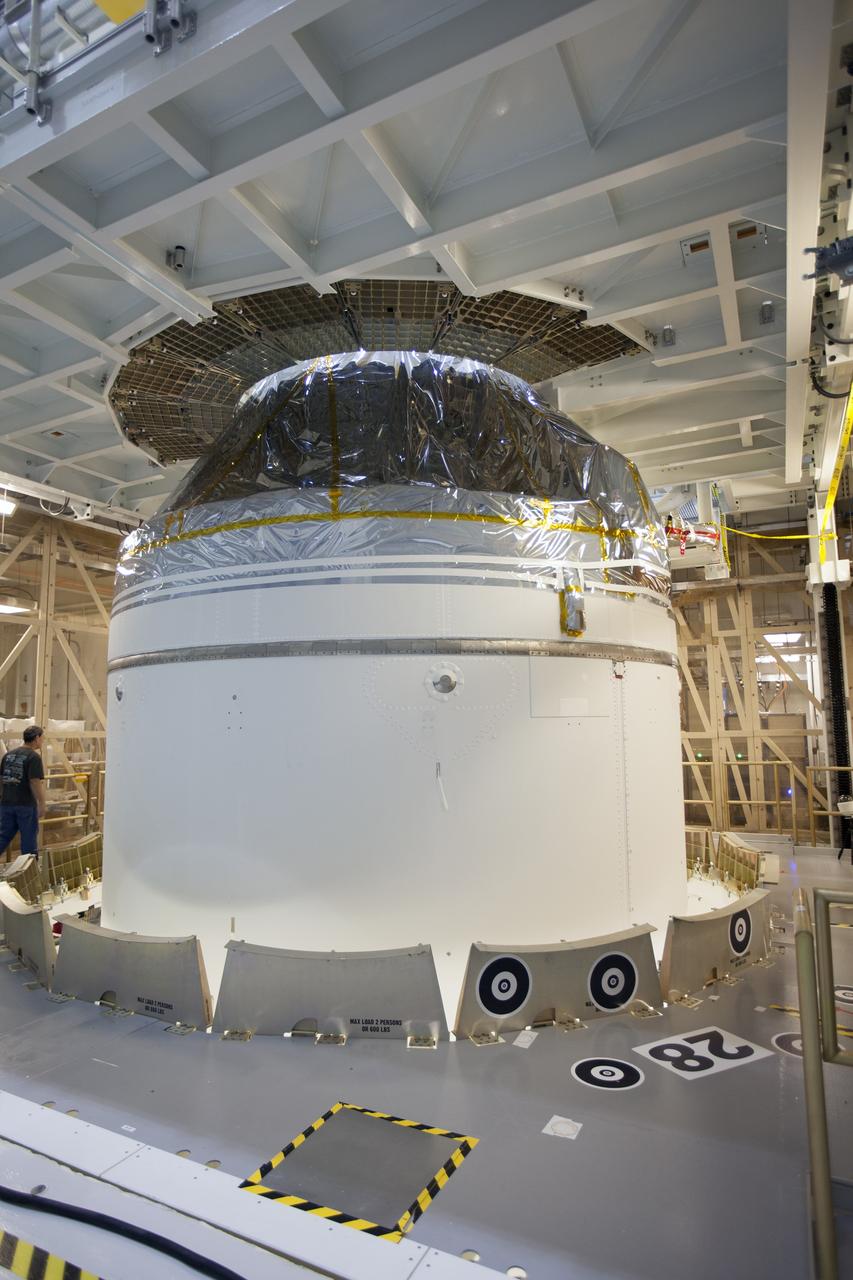 CAPE CANAVERAL, Fla. – Inside the Neil Armstrong Operations and Checkout Building high bay at NASA's Kennedy Space Center in Florida, preparations are underway to lift the Orion crew and service module stack for Exploration Flight Test-1 out of the test cell and transfer it to a mating device.     Orion is the exploration spacecraft designed to carry astronauts to destinations not yet explored by humans, including an asteroid and Mars. It will have emergency abort capability, sustain the crew during space travel and provide safe re-entry from deep space return velocities. The first unpiloted test flight of the Orion is scheduled to launch later this year atop a Delta IV Heavy rocket from Cape Canaveral Air Force Station in Florida to an altitude of 3,600 miles above the Earth's surface. The two-orbit, four-hour flight test will help engineers evaluate the systems critical to crew safety including the heat shield, parachute system and launch abort system. For more information, visit http://www.nasa.gov/orion. Photo credit: NASA/Ben Smegelsky