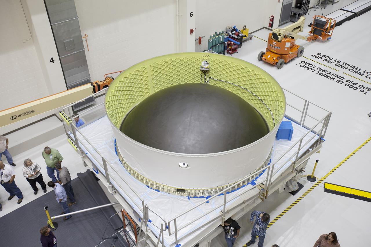 CAPE CANAVERAL, Fla. – Inside the Neil Armstrong Operations and Checkout Building high bay at NASA's Kennedy Space Center in Florida, a mating device is positioned on a work stand. Preparations are underway to lift the Orion crew and service module stack for Exploration Flight Test-1 out of the test cell and transfer it to the mating device.     Orion is the exploration spacecraft designed to carry astronauts to destinations not yet explored by humans, including an asteroid and Mars. It will have emergency abort capability, sustain the crew during space travel and provide safe re-entry from deep space return velocities. The first unpiloted test flight of the Orion is scheduled to launch later this year atop a Delta IV Heavy rocket from Cape Canaveral Air Force Station in Florida to an altitude of 3,600 miles above the Earth's surface. The two-orbit, four-hour flight test will help engineers evaluate the systems critical to crew safety including the heat shield, parachute system and launch abort system. For more information, visit http://www.nasa.gov/orion. Photo credit: NASA/Ben Smegelsky