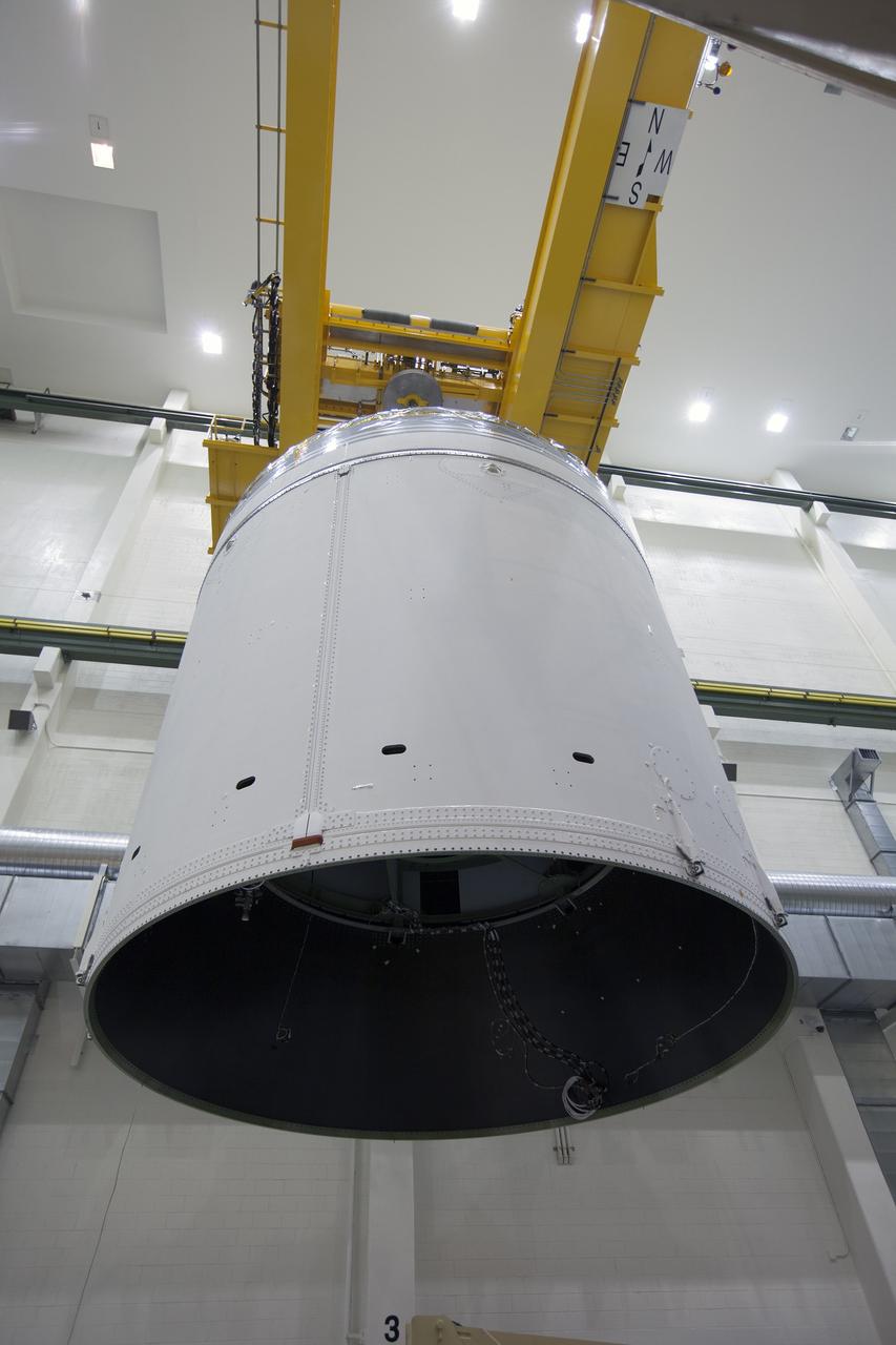 CAPE CANAVERAL, Fla. – Inside the Neil Armstrong Operations and Checkout Building high bay at NASA's Kennedy Space Center in Florida, the Orion crew and service module stack for Exploration Flight Test-1 was lifted by crane out of the test cell and is being moved along the center aisle. Orion will be transferred to a mating device.     Orion is the exploration spacecraft designed to carry astronauts to destinations not yet explored by humans, including an asteroid and Mars. It will have emergency abort capability, sustain the crew during space travel and provide safe re-entry from deep space return velocities. The first unpiloted test flight of the Orion is scheduled to launch later this year atop a Delta IV Heavy rocket from Cape Canaveral Air Force Station in Florida to an altitude of 3,600 miles above the Earth's surface. The two-orbit, four-hour flight test will help engineers evaluate the systems critical to crew safety including the heat shield, parachute system and launch abort system. For more information, visit http://www.nasa.gov/orion. Photo credit: NASA/Ben Smegelsky
