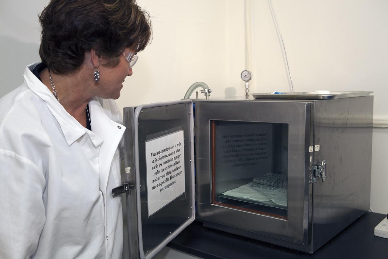 CAPE CANAVERAL, Fla. – Inside a laboratory in the Space Station Processing Facility at NASA's Kennedy Space Center in Florida, April Spinale, a payload integration specialist with Bionetics, places a set of vials for the Protein Crystal Growth 2 experiment into a vacuum chamber for an acceptance leak test. The vials have been filled with clear water and the test will verify that the hardware is providing adequate containment for the liquids. Spinale is a consultants for the Center for Advancement of Science in Space, or CASIS. The experiment is one of many that will be delivered to the International Space Station on the SpaceX-4 commercial cargo resupply mission. Kennedy's ISS Ground Processing and Research Project Office is providing the necessary laboratories, equipment, supplies and consumables for 61 principal investigators, including 17 from other countries, as they prepare their science experiments for flight. The SpaceX-4 flight is targeted to launch in September 2014. Photo credit: NASA/Dimitri Gerondidakis