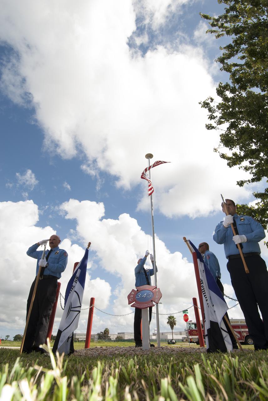 Cape Canaveral, Fla. – At Fire Station 1 at NASA’s Kennedy Space Center in Florida, Fire and Rescue personnel salute or stand at attention as the American flag is raised during a ceremony held by Kennedy’s Fire and Rescue personnel. Kennedy Fire and Rescue Services commemorated the 13th anniversary of 9/11 with a ceremony that included a minute of silence at 10:28 a.m., which was the moment of collapse of the north tower of the World Trade Center. Photo credit: Jim Grossmann