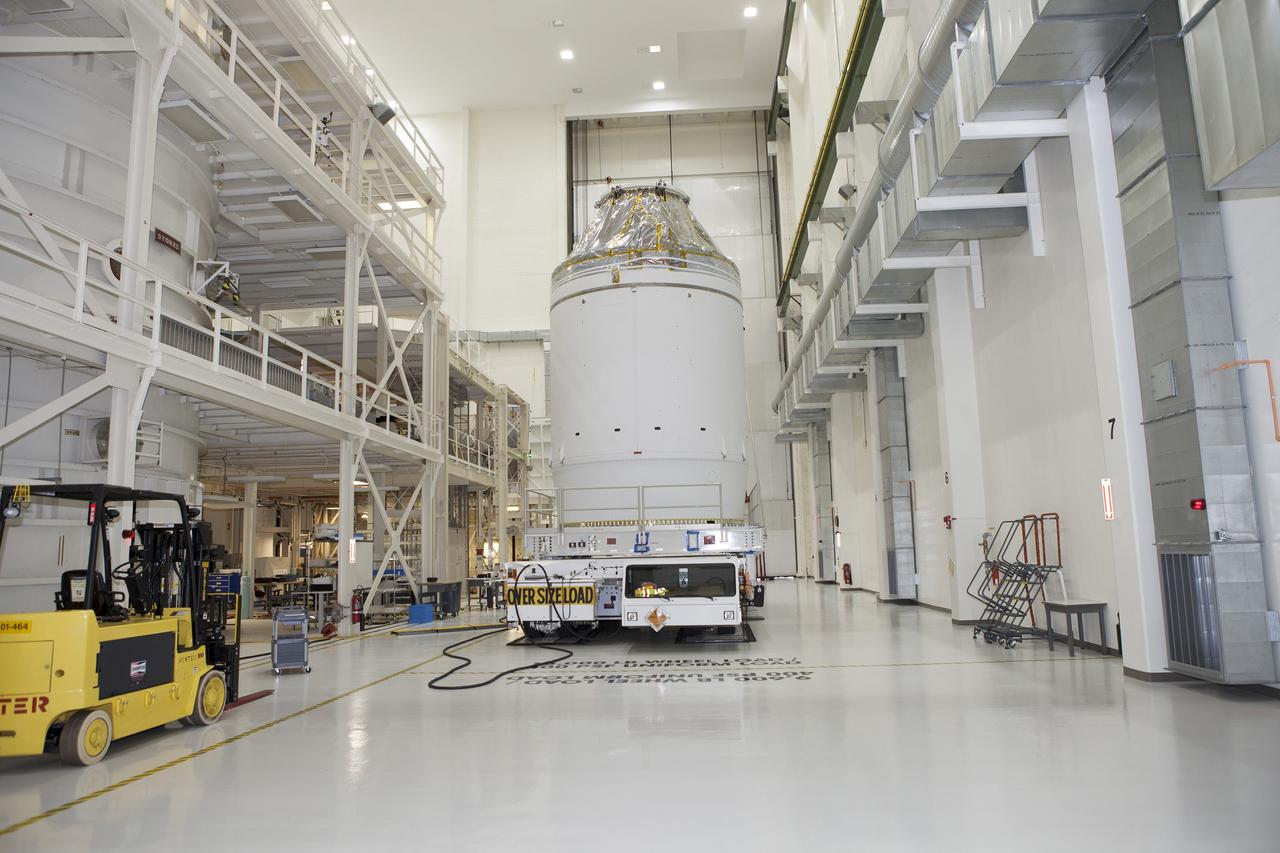 CAPE CANAVERAL, Fla. – The Orion crew module, stacked atop its service module, is being prepared for its move out of the Neil Armstrong Operations and Checkout Building high bay at NASA's Kennedy Space Center in Florida. The spacecraft for Exploration Flight Test-1 will be transported to the Payload Hazardous Servicing Facility where it will be fueled ahead of its December flight test. Orion is the exploration spacecraft designed to carry astronauts to destinations not yet explored by humans, including an asteroid and Mars. It will have emergency abort capability, sustain the crew during space travel and provide safe re-entry from deep space return velocities. The first unpiloted test flight of the Orion is scheduled to launch atop a United Launch Alliance Delta IV Heavy rocket from Cape Canaveral Air Force Station in Florida to an altitude of 3,600 miles above the Earth's surface. The two-orbit, four-hour flight test will help engineers evaluate the systems critical to crew safety including the heat shield, parachute system and launch abort system. For more information, visit http://www.nasa.gov/orion. Photo credit: NASA/Daniel Casper