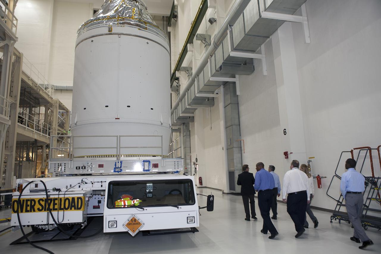 CAPE CANAVERAL, Fla. – The Orion crew module, stacked atop its service module, is being prepared for its move out of the Neil Armstrong Operations and Checkout Building high bay at NASA's Kennedy Space Center in Florida. The spacecraft for Exploration Flight Test-1 will be transported to the Payload Hazardous Servicing Facility where it will be fueled ahead of its December flight test. Orion is the exploration spacecraft designed to carry astronauts to destinations not yet explored by humans, including an asteroid and Mars. It will have emergency abort capability, sustain the crew during space travel and provide safe re-entry from deep space return velocities. The first unpiloted test flight of the Orion is scheduled to launch atop a United Launch Alliance Delta IV Heavy rocket from Cape Canaveral Air Force Station in Florida to an altitude of 3,600 miles above the Earth's surface. The two-orbit, four-hour flight test will help engineers evaluate the systems critical to crew safety including the heat shield, parachute system and launch abort system. For more information, visit http://www.nasa.gov/orion. Photo credit: NASA/Daniel Casper