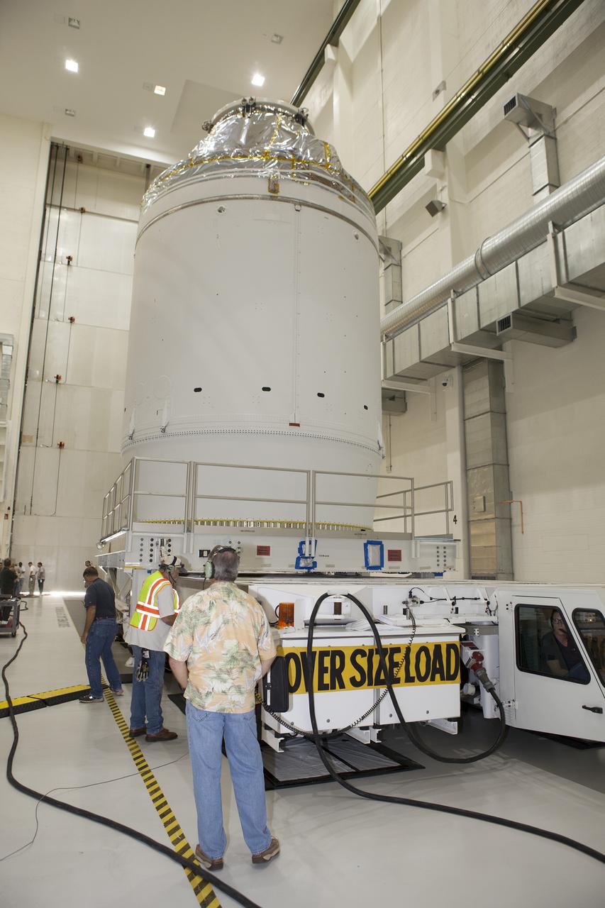 CAPE CANAVERAL, Fla. – The Orion crew module, stacked atop its service module, is being prepared for its move out of the Neil Armstrong Operations and Checkout Building high bay at NASA's Kennedy Space Center in Florida. The spacecraft for Exploration Flight Test-1 will be transported to the Payload Hazardous Servicing Facility where it will be fueled ahead of its December flight test.    Orion is the exploration spacecraft designed to carry astronauts to destinations not yet explored by humans, including an asteroid and Mars. It will have emergency abort capability, sustain the crew during space travel and provide safe re-entry from deep space return velocities. The first unpiloted test flight of the Orion is scheduled to launch atop a United Launch Alliance Delta IV Heavy rocket from Cape Canaveral Air Force Station in Florida to an altitude of 3,600 miles above the Earth's surface. The two-orbit, four-hour flight test will help engineers evaluate the systems critical to crew safety including the heat shield, parachute system and launch abort system. For more information, visit http://www.nasa.gov/orion. Photo credit: NASA/Daniel Casper
