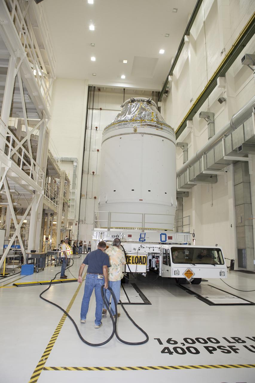 CAPE CANAVERAL, Fla. – The Orion crew module, stacked atop its service module, is being prepared for its move out of the Neil Armstrong Operations and Checkout Building high bay at NASA's Kennedy Space Center in Florida. The spacecraft for Exploration Flight Test-1 will be transported to the Payload Hazardous Servicing Facility where it will be fueled ahead of its December flight test.    Orion is the exploration spacecraft designed to carry astronauts to destinations not yet explored by humans, including an asteroid and Mars. It will have emergency abort capability, sustain the crew during space travel and provide safe re-entry from deep space return velocities. The first unpiloted test flight of the Orion is scheduled to launch atop a United Launch Alliance Delta IV Heavy rocket from Cape Canaveral Air Force Station in Florida to an altitude of 3,600 miles above the Earth's surface. The two-orbit, four-hour flight test will help engineers evaluate the systems critical to crew safety including the heat shield, parachute system and launch abort system. For more information, visit http://www.nasa.gov/orion. Photo credit: NASA/Daniel Casper