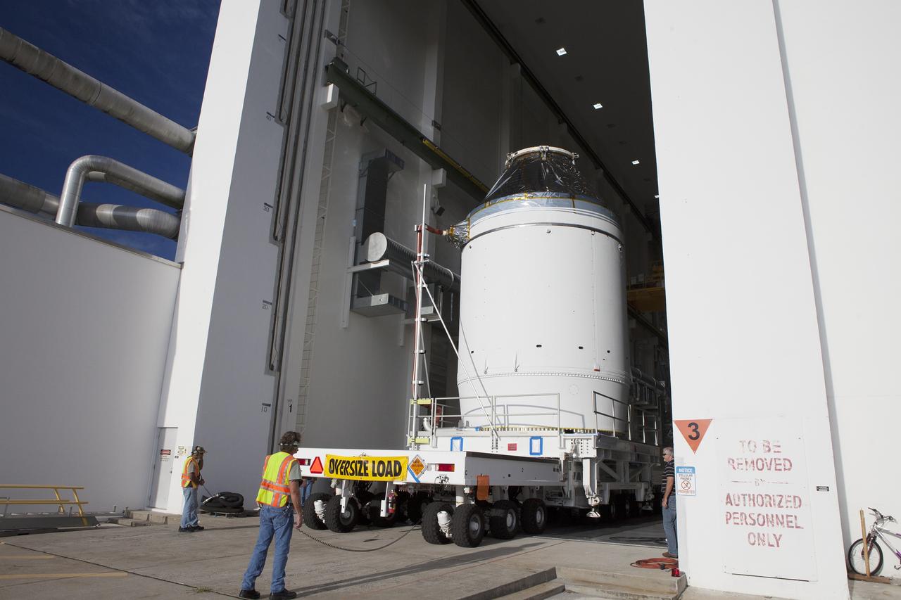 CAPE CANAVERAL, Fla. – The Orion crew module, stacked atop its service module, is moved slowly out of the Neil Armstrong Operations and Checkout Building high bay door at NASA's Kennedy Space Center in Florida. The spacecraft for Exploration Flight Test-1 will be transported to the Payload Hazardous Servicing Facility where it will be fueled ahead of its December flight test. Orion is the exploration spacecraft designed to carry astronauts to destinations not yet explored by humans, including an asteroid and Mars. It will have emergency abort capability, sustain the crew during space travel and provide safe re-entry from deep space return velocities. The first unpiloted test flight of the Orion is scheduled to launch atop a United Launch Alliance Delta IV Heavy rocket from Cape Canaveral Air Force Station in Florida to an altitude of 3,600 miles above the Earth's surface. The two-orbit, four-hour flight test will help engineers evaluate the systems critical to crew safety including the heat shield, parachute system and launch abort system. For more information, visit http://www.nasa.gov/orion. Photo credit: NASA/Daniel Casper