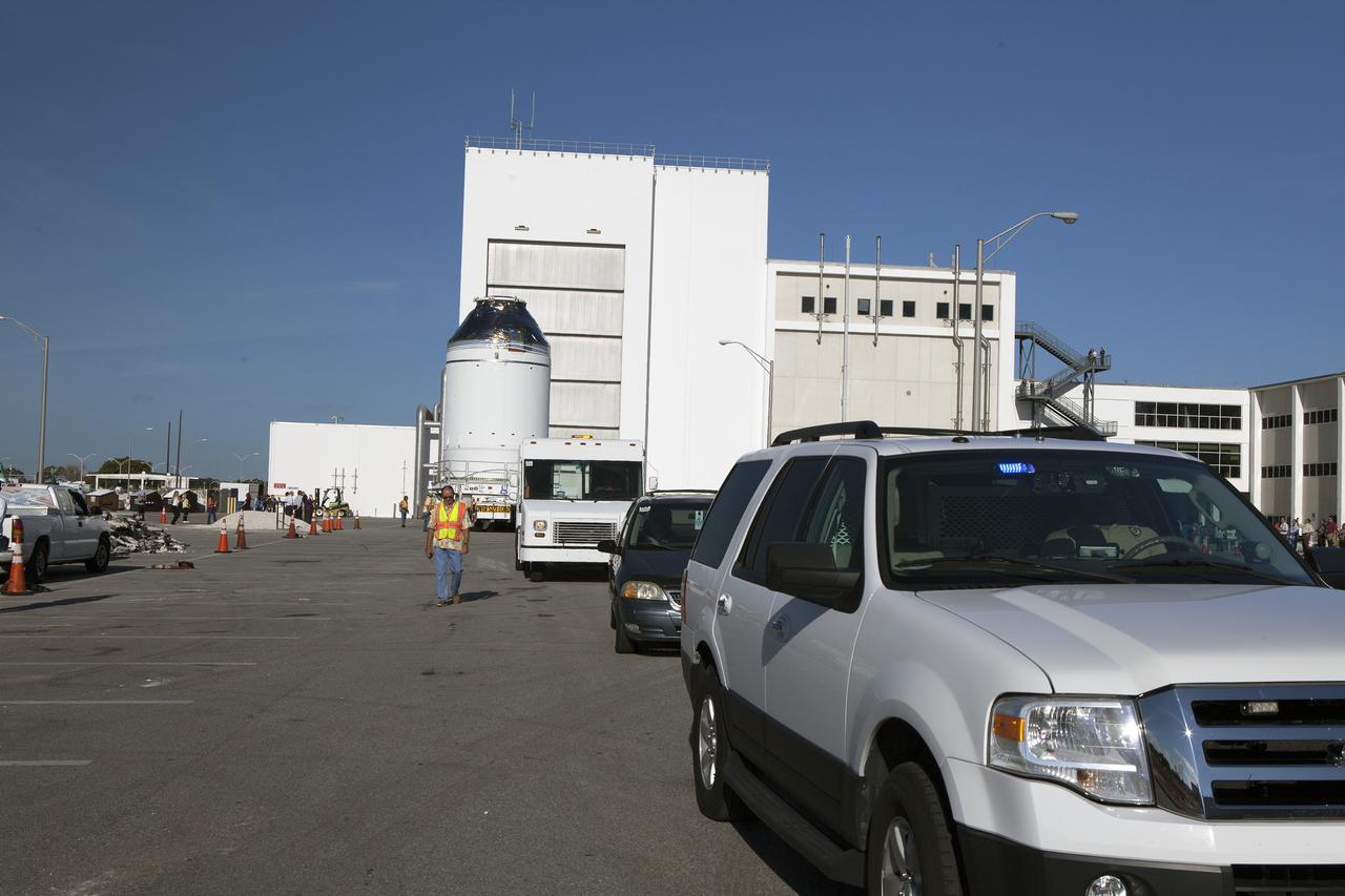CAPE CANAVERAL, Fla. – The Orion crew module, stacked atop its service module, has moved out of the Neil Armstrong Operations and Checkout Building high bay at NASA's Kennedy Space Center in Florida. A convoy leads the way as the spacecraft for Exploration Flight Test-1 begins its trek to the Payload Hazardous Servicing Facility where it will be fueled ahead of its December flight test. Orion is the exploration spacecraft designed to carry astronauts to destinations not yet explored by humans, including an asteroid and Mars. It will have emergency abort capability, sustain the crew during space travel and provide safe re-entry from deep space return velocities. The first unpiloted test flight of the Orion is scheduled to launch atop a United Launch Alliance Delta IV Heavy rocket from Cape Canaveral Air Force Station in Florida to an altitude of 3,600 miles above the Earth's surface. The two-orbit, four-hour flight test will help engineers evaluate the systems critical to crew safety including the heat shield, parachute system and launch abort system. For more information, visit http://www.nasa.gov/orion. Photo credit: NASA/Daniel Casper