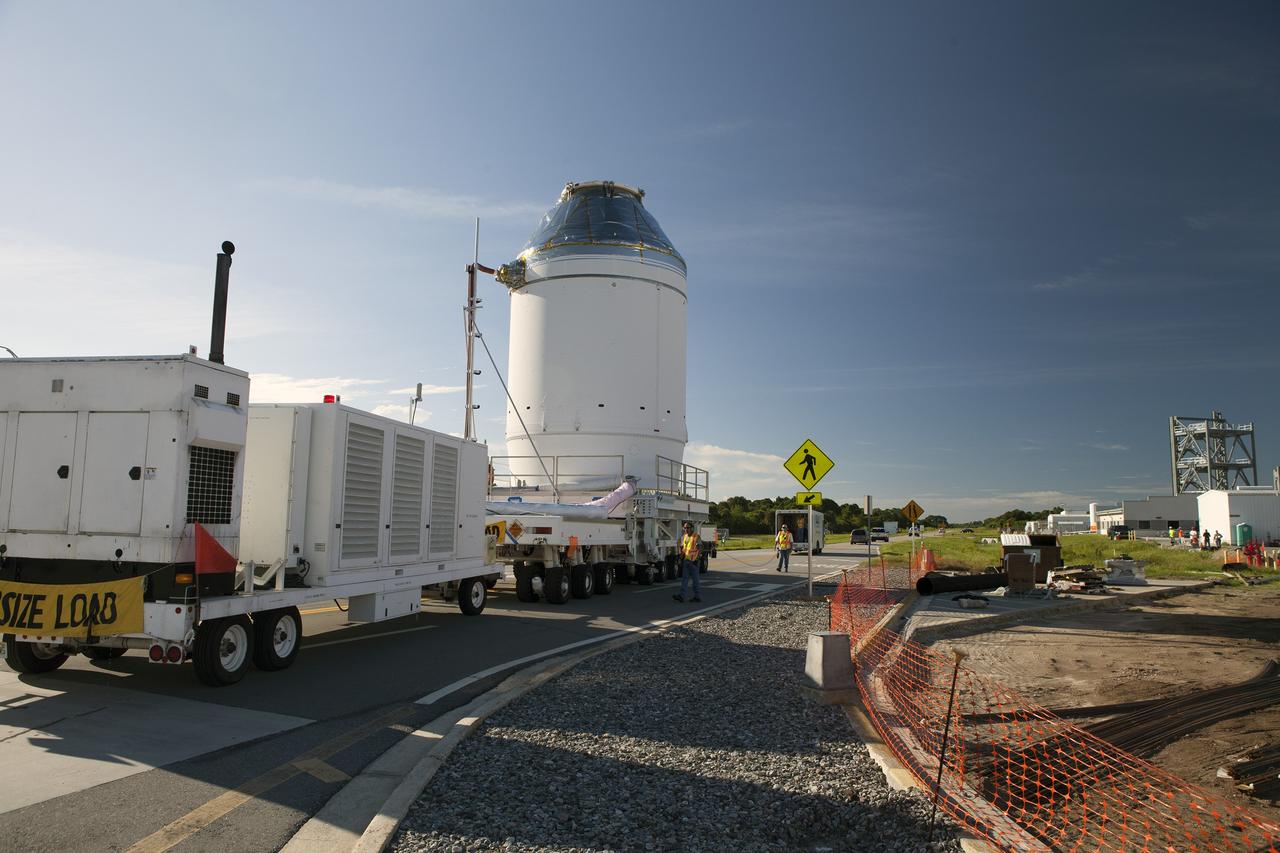 CAPE CANAVERAL, Fla. – The Orion crew module, stacked atop its service module, has moved out of the Neil Armstrong Operations and Checkout Building high bay at NASA's Kennedy Space Center in Florida. The spacecraft for Exploration Flight Test-1 is being transported to the Payload Hazardous Servicing Facility where it will be fueled ahead of its December flight test.    Orion is the exploration spacecraft designed to carry astronauts to destinations not yet explored by humans, including an asteroid and Mars. It will have emergency abort capability, sustain the crew during space travel and provide safe re-entry from deep space return velocities. The first unpiloted test flight of the Orion is scheduled to launch atop a United Launch Alliance Delta IV Heavy rocket from Cape Canaveral Air Force Station in Florida to an altitude of 3,600 miles above the Earth's surface. The two-orbit, four-hour flight test will help engineers evaluate the systems critical to crew safety including the heat shield, parachute system and launch abort system. For more information, visit http://www.nasa.gov/orion. Photo credit: NASA/Daniel Casper