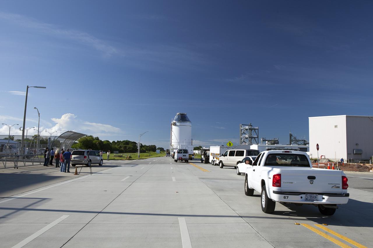 CAPE CANAVERAL, Fla. – The Orion crew module, stacked atop its service module, has moved out of the Neil Armstrong Operations and Checkout Building high bay at NASA's Kennedy Space Center in Florida. The spacecraft for Exploration Flight Test-1 is being transported to the Payload Hazardous Servicing Facility where it will be fueled ahead of its December flight test.    Orion is the exploration spacecraft designed to carry astronauts to destinations not yet explored by humans, including an asteroid and Mars. It will have emergency abort capability, sustain the crew during space travel and provide safe re-entry from deep space return velocities. The first unpiloted test flight of the Orion is scheduled to launch atop a United Launch Alliance Delta IV Heavy rocket from Cape Canaveral Air Force Station in Florida to an altitude of 3,600 miles above the Earth's surface. The two-orbit, four-hour flight test will help engineers evaluate the systems critical to crew safety including the heat shield, parachute system and launch abort system. For more information, visit http://www.nasa.gov/orion. Photo credit: NASA/Daniel Casper