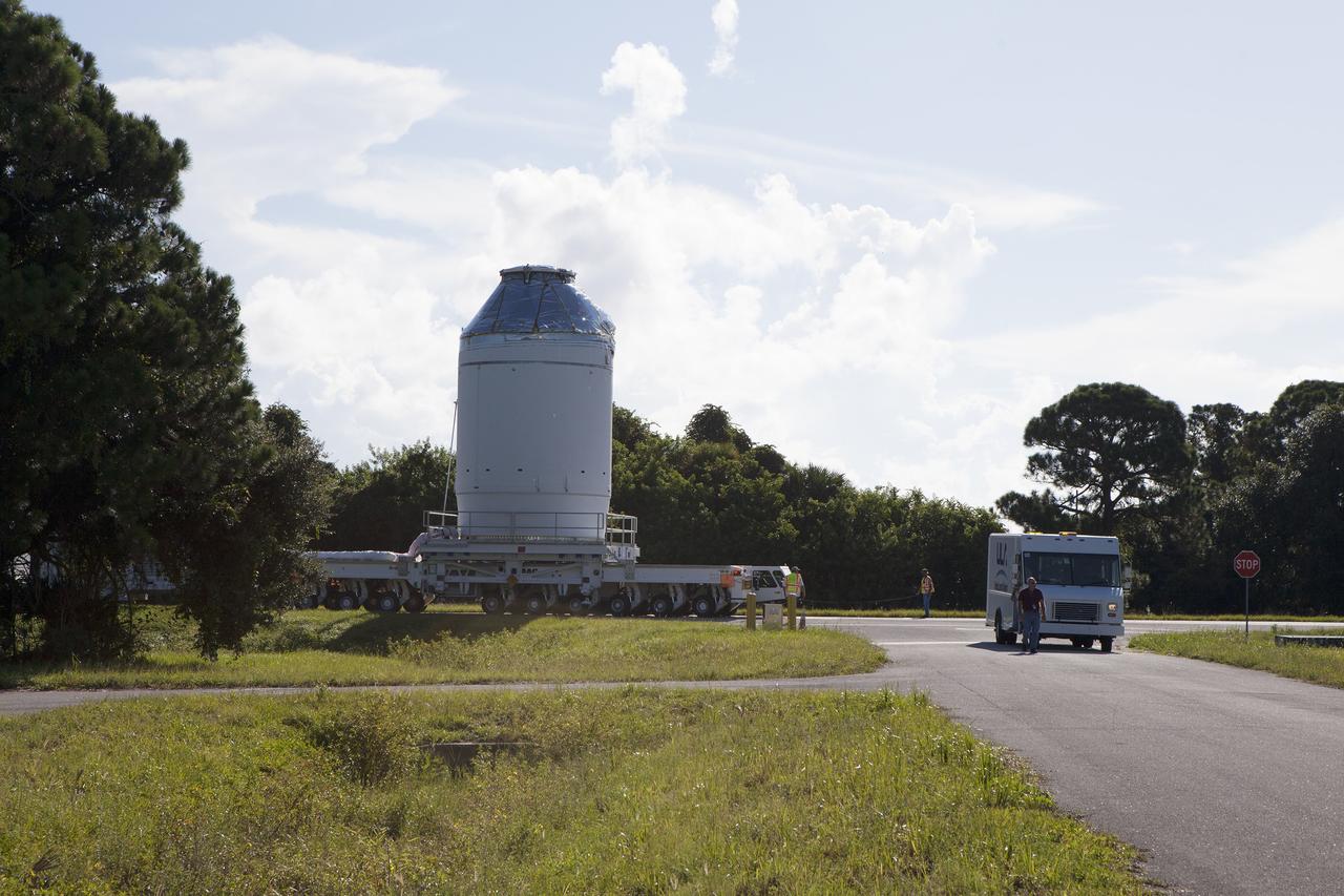 CAPE CANAVERAL, Fla. – The Orion crew module, stacked atop its service module, is being transported to the Payload Hazardous Servicing Facility at NASA's Kennedy Space Center in Florida, where it will be fueled ahead of its December flight. The spacecraft for Exploration Flight Test-1 was moved out of the Neil Armstrong Operations and Checkout Building high bay.     Orion is the exploration spacecraft designed to carry astronauts to destinations not yet explored by humans, including an asteroid and Mars. It will have emergency abort capability, sustain the crew during space travel and provide safe re-entry from deep space return velocities. The first unpiloted test flight of the Orion is scheduled to launch atop a United Launch Alliance Delta IV Heavy rocket from Cape Canaveral Air Force Station in Florida to an altitude of 3,600 miles above the Earth's surface. The two-orbit, four-hour flight test will help engineers evaluate the systems critical to crew safety including the heat shield, parachute system and launch abort system. For more information, visit http://www.nasa.gov/orion. Photo credit: NASA/Daniel Casper