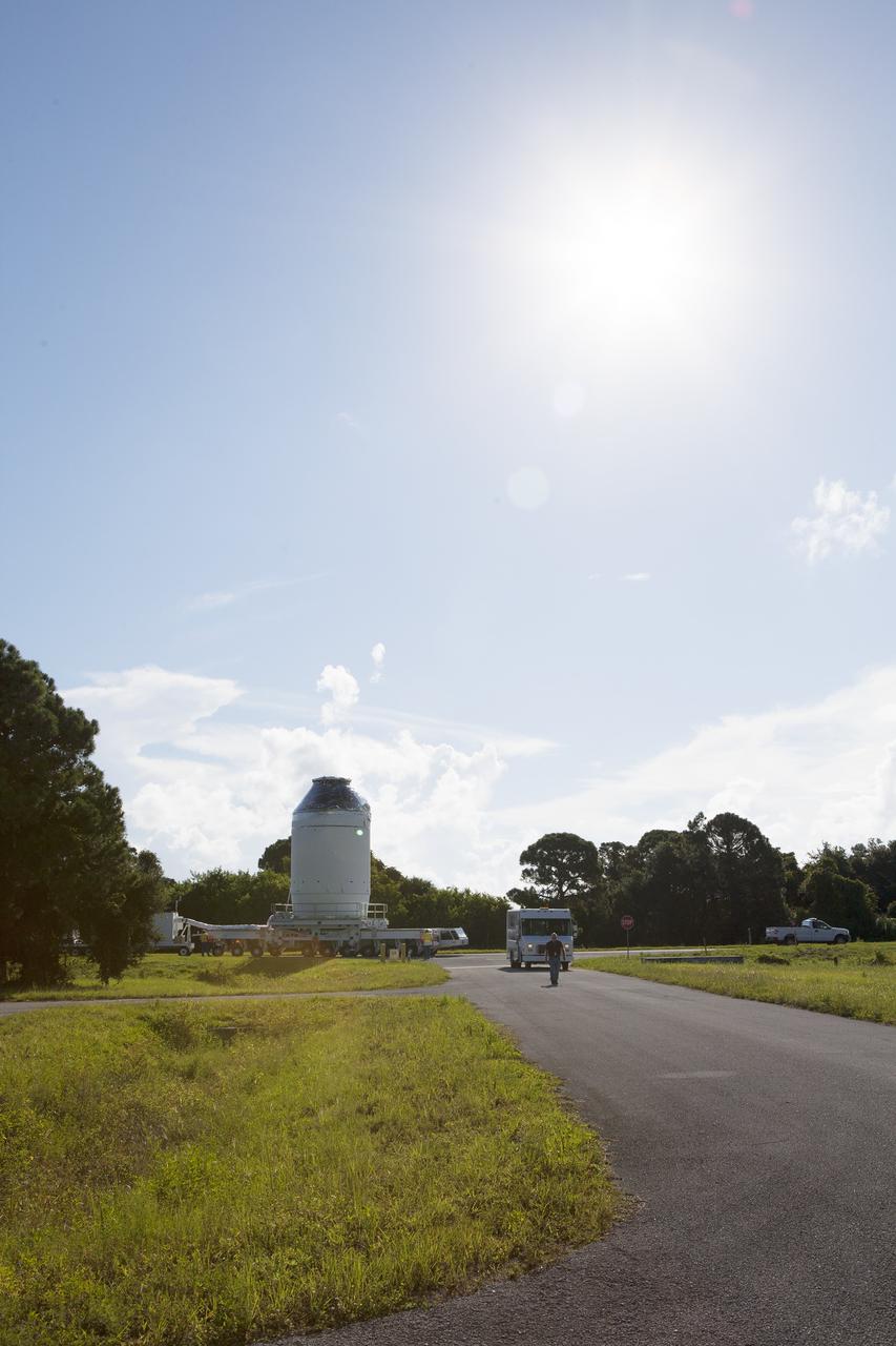 CAPE CANAVERAL, Fla. – The Orion crew module, stacked atop its service module, is being transported to the Payload Hazardous Servicing Facility at NASA's Kennedy Space Center in Florida, where it will be fueled ahead of its December flight. The spacecraft for Exploration Flight Test-1 was moved out of the Neil Armstrong Operations and Checkout Building high bay.     Orion is the exploration spacecraft designed to carry astronauts to destinations not yet explored by humans, including an asteroid and Mars. It will have emergency abort capability, sustain the crew during space travel and provide safe re-entry from deep space return velocities. The first unpiloted test flight of the Orion is scheduled to launch atop a United Launch Alliance Delta IV Heavy rocket from Cape Canaveral Air Force Station in Florida to an altitude of 3,600 miles above the Earth's surface. The two-orbit, four-hour flight test will help engineers evaluate the systems critical to crew safety including the heat shield, parachute system and launch abort system. For more information, visit http://www.nasa.gov/orion. Photo credit: NASA/Daniel Casper