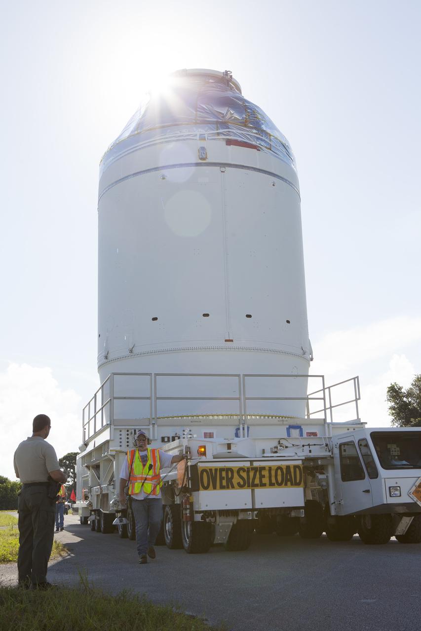 CAPE CANAVERAL, Fla. – The Orion crew module, stacked atop its service module, is being transported to the Payload Hazardous Servicing Facility at NASA's Kennedy Space Center in Florida, where it will be fueled ahead of its December flight. The spacecraft for Exploration Flight Test-1 was moved out of the Neil Armstrong Operations and Checkout Building high bay.    Orion is the exploration spacecraft designed to carry astronauts to destinations not yet explored by humans, including an asteroid and Mars. It will have emergency abort capability, sustain the crew during space travel and provide safe re-entry from deep space return velocities. The first unpiloted test flight of the Orion is scheduled to launch atop a United Launch Alliance Delta IV Heavy rocket from Cape Canaveral Air Force Station in Florida to an altitude of 3,600 miles above the Earth's surface. The two-orbit, four-hour flight test will help engineers evaluate the systems critical to crew safety including the heat shield, parachute system and launch abort system. For more information, visit http://www.nasa.gov/orion. Photo credit: NASA/Daniel Casper