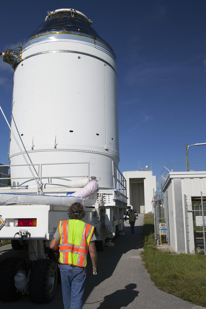 CAPE CANAVERAL, Fla. – The Orion crew module, stacked atop its service module, is being transported to the Payload Hazardous Servicing Facility at NASA's Kennedy Space Center in Florida, where it will be fueled ahead of its December flight. The spacecraft for Exploration Flight Test-1 was moved out of the Neil Armstrong Operations and Checkout Building high bay. Orion is the exploration spacecraft designed to carry astronauts to destinations not yet explored by humans, including an asteroid and Mars. It will have emergency abort capability, sustain the crew during space travel and provide safe re-entry from deep space return velocities. The first unpiloted test flight of the Orion is scheduled to launch atop a United Launch Alliance Delta IV Heavy rocket from Cape Canaveral Air Force Station in Florida to an altitude of 3,600 miles above the Earth's surface. The two-orbit, four-hour flight test will help engineers evaluate the systems critical to crew safety including the heat shield, parachute system and launch abort system. For more information, visit http://www.nasa.gov/orion. Photo credit: NASA/Daniel Casper