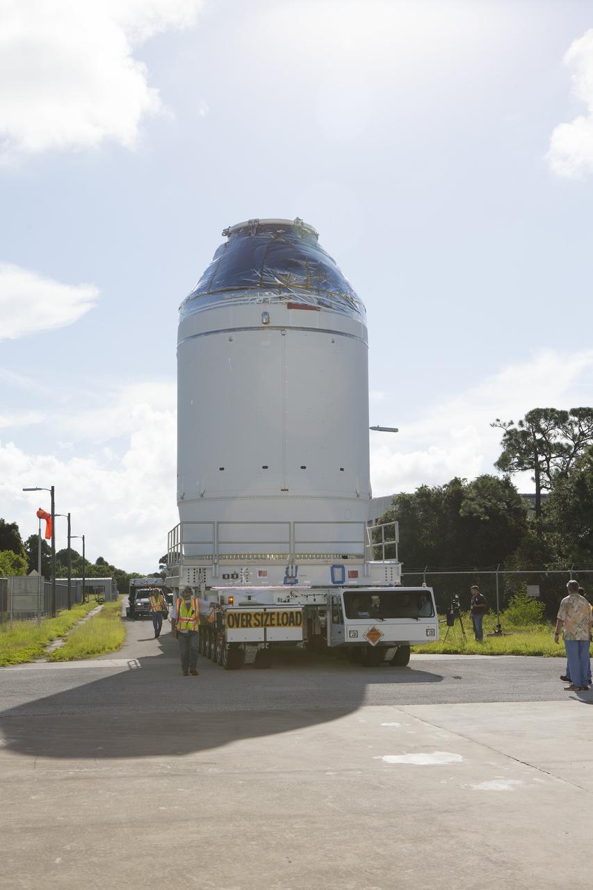 CAPE CANAVERAL, Fla. – The Orion crew module, stacked atop its service module, is being transported to the Payload Hazardous Servicing Facility at NASA's Kennedy Space Center in Florida, where it will be fueled ahead of its December flight. The spacecraft for Exploration Flight Test-1 was moved out of the Neil Armstrong Operations and Checkout Building high bay.    Orion is the exploration spacecraft designed to carry astronauts to destinations not yet explored by humans, including an asteroid and Mars. It will have emergency abort capability, sustain the crew during space travel and provide safe re-entry from deep space return velocities. The first unpiloted test flight of the Orion is scheduled to launch atop a United Launch Alliance Delta IV Heavy rocket from Cape Canaveral Air Force Station in Florida to an altitude of 3,600 miles above the Earth's surface. The two-orbit, four-hour flight test will help engineers evaluate the systems critical to crew safety including the heat shield, parachute system and launch abort system. For more information, visit http://www.nasa.gov/orion. Photo credit: NASA/Daniel Casper