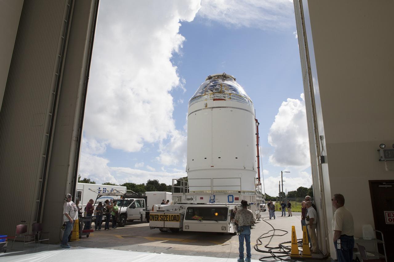 CAPE CANAVERAL, Fla. – The Orion crew module, stacked atop its service module, is transported into the Payload Hazardous Servicing Facility at NASA's Kennedy Space Center in Florida, where it will be fueled ahead of its December flight. The spacecraft for Exploration Flight Test-1 was moved out of the Neil Armstrong Operations and Checkout Building high bay.    Orion is the exploration spacecraft designed to carry astronauts to destinations not yet explored by humans, including an asteroid and Mars. It will have emergency abort capability, sustain the crew during space travel and provide safe re-entry from deep space return velocities. The first unpiloted test flight of the Orion is scheduled to launch atop a United Launch Alliance Delta IV Heavy rocket from Cape Canaveral Air Force Station in Florida to an altitude of 3,600 miles above the Earth's surface. The two-orbit, four-hour flight test will help engineers evaluate the systems critical to crew safety including the heat shield, parachute system and launch abort system. For more information, visit http://www.nasa.gov/orion. Photo credit: NASA/Daniel Casper