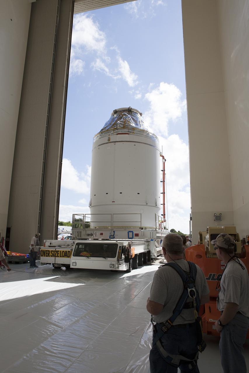 CAPE CANAVERAL, Fla. – The Orion crew module, stacked atop its service module, is transported into the Payload Hazardous Servicing Facility at NASA's Kennedy Space Center in Florida, where it will be fueled ahead of its December flight. The spacecraft for Exploration Flight Test-1 was moved out of the Neil Armstrong Operations and Checkout Building high bay. Orion is the exploration spacecraft designed to carry astronauts to destinations not yet explored by humans, including an asteroid and Mars. It will have emergency abort capability, sustain the crew during space travel and provide safe re-entry from deep space return velocities. The first unpiloted test flight of the Orion is scheduled to launch atop a United Launch Alliance Delta IV Heavy rocket from Cape Canaveral Air Force Station in Florida to an altitude of 3,600 miles above the Earth's surface. The two-orbit, four-hour flight test will help engineers evaluate the systems critical to crew safety including the heat shield, parachute system and launch abort system. For more information, visit http://www.nasa.gov/orion. Photo credit: NASA/Daniel Casper