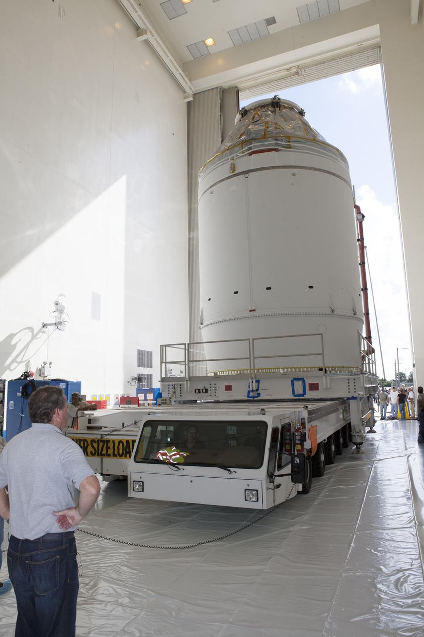 CAPE CANAVERAL, Fla. – The Orion crew module, stacked atop its service module, is transported into the Payload Hazardous Servicing Facility at NASA's Kennedy Space Center in Florida, where it will be fueled ahead of its December flight. The spacecraft for Exploration Flight Test-1 was moved out of the Neil Armstrong Operations and Checkout Building high bay. Orion is the exploration spacecraft designed to carry astronauts to destinations not yet explored by humans, including an asteroid and Mars. It will have emergency abort capability, sustain the crew during space travel and provide safe re-entry from deep space return velocities. The first unpiloted test flight of the Orion is scheduled to launch atop a United Launch Alliance Delta IV Heavy rocket from Cape Canaveral Air Force Station in Florida to an altitude of 3,600 miles above the Earth's surface. The two-orbit, four-hour flight test will help engineers evaluate the systems critical to crew safety including the heat shield, parachute system and launch abort system. For more information, visit http://www.nasa.gov/orion. Photo credit: NASA/Daniel Casper