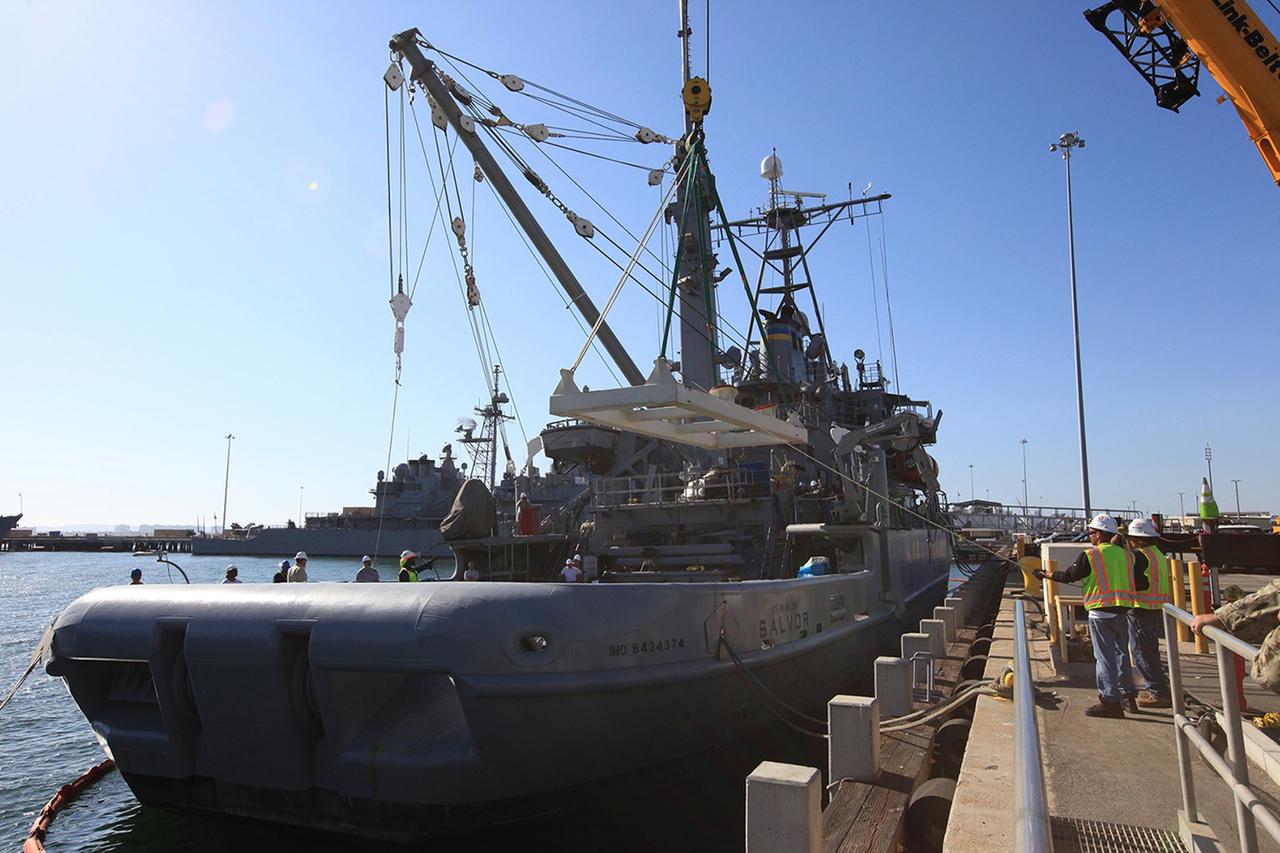 SAN DIEGO, Calif. – The USS Salvor, a safeguard-class rescue and salvage ship, is docked at Naval Base San Diego in California. Preparations are underway to load the Orion boilerplate test vehicle and associated hardware onto the ship for Underway Recovery Test 4A. The ship will head out to sea for four days to test crew module crane recovery operations. NASA, Lockheed Martin and the U.S. Navy are conducting the test to prepare for recovery of the Orion crew module on its return from a deep space mission. The underway recovery test will allow the teams to demonstrate and evaluate the recovery processes, procedures, new hardware and personnel in open waters.    The Ground Systems Development and Operations Program is conducting the underway recovery test. Orion is the exploration spacecraft designed to carry astronauts to destinations not yet explored by humans, including an asteroid and Mars. It will have emergency abort capability, sustain the crew during space travel and provide safe re-entry from deep space return velocities. The first unpiloted test flight of the Orion is scheduled to launch in December 2014 atop a United Launch Alliance Delta IV rocket and in 2018 on NASA’s Space Launch System rocket. For more information, visit http://www.nasa.gov/orion. Photo credit: Kim Shiflett