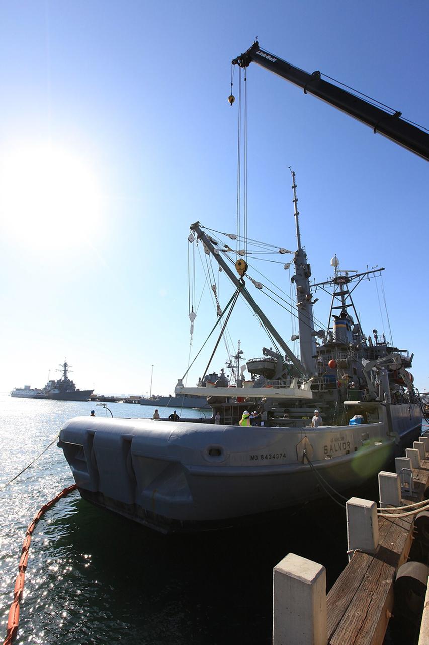 SAN DIEGO, Calif. – The USS Salvor, a safeguard-class rescue and salvage ship, is docked at Naval Base San Diego in California. Preparations are underway to load the Orion boilerplate test vehicle and associated hardware onto the ship for Underway Recovery Test 4A. The ship will head out to sea for four days to test crew module crane recovery operations. NASA, Lockheed Martin and the U.S. Navy are conducting the test to prepare for recovery of the Orion crew module on its return from a deep space mission. The underway recovery test will allow the teams to demonstrate and evaluate the recovery processes, procedures, new hardware and personnel in open waters. The Ground Systems Development and Operations Program is conducting the underway recovery test. Orion is the exploration spacecraft designed to carry astronauts to destinations not yet explored by humans, including an asteroid and Mars. It will have emergency abort capability, sustain the crew during space travel and provide safe re-entry from deep space return velocities. The first unpiloted test flight of the Orion is scheduled to launch in December 2014 atop a United Launch Alliance Delta IV rocket and in 2018 on NASA’s Space Launch System rocket. For more information, visit http://www.nasa.gov/orion. Photo credit: Kim Shiflett