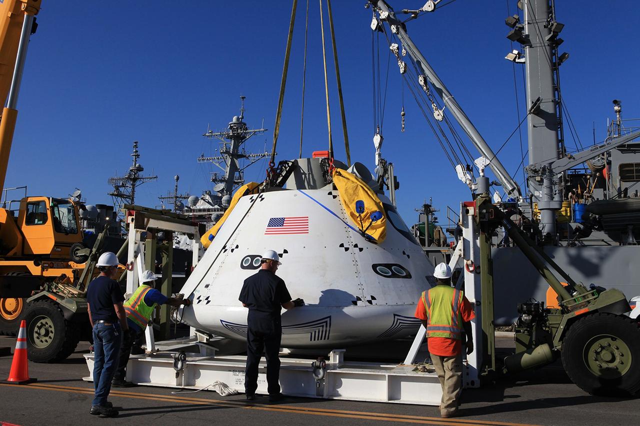 SAN DIEGO, Calif. – At Naval Base San Diego in California, a crane is used to lift the Orion boilerplate test vehicle out of its cradle and transfer it to the USS Salvor, a safeguard-class rescue and salvage ship that will be used for Underway Recovery Test 4A. The ship will head out to sea for four days to test crew module crane recovery operations. NASA, Lockheed Martin and the U.S. Navy are conducting the test to prepare for recovery of the Orion crew module on its return from a deep space mission. The underway recovery test will allow the teams to demonstrate and evaluate the recovery processes, procedures, new hardware and personnel in open waters.    The Ground Systems Development and Operations Program is conducting the underway recovery test. Orion is the exploration spacecraft designed to carry astronauts to destinations not yet explored by humans, including an asteroid and Mars. It will have emergency abort capability, sustain the crew during space travel and provide safe re-entry from deep space return velocities. The first unpiloted test flight of the Orion is scheduled to launch in December 2014 atop a United Launch Alliance Delta IV rocket and in 2018 on NASA’s Space Launch System rocket. For more information, visit http://www.nasa.gov/orion. Photo credit: Kim Shiflett
