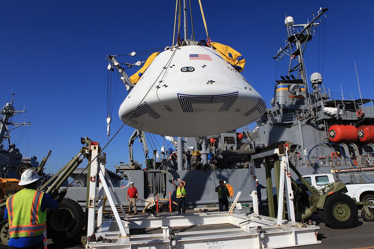 SAN DIEGO, Calif. – At Naval Base San Diego in California, a crane is used to lift the Orion boilerplate test vehicle out of its cradle and transfer it to the USS Salvor, a safeguard-class rescue and salvage ship that will be used for Underway Recovery Test 4A. The ship will head out to sea for four days to test crew module crane recovery operations. NASA, Lockheed Martin and the U.S. Navy are conducting the test to prepare for recovery of the Orion crew module on its return from a deep space mission. The underway recovery test will allow the teams to demonstrate and evaluate the recovery processes, procedures, new hardware and personnel in open waters. The Ground Systems Development and Operations Program is conducting the underway recovery test. Orion is the exploration spacecraft designed to carry astronauts to destinations not yet explored by humans, including an asteroid and Mars. It will have emergency abort capability, sustain the crew during space travel and provide safe re-entry from deep space return velocities. The first unpiloted test flight of the Orion is scheduled to launch in December 2014 atop a United Launch Alliance Delta IV rocket and in 2018 on NASA’s Space Launch System rocket. For more information, visit http://www.nasa.gov/orion. Photo credit: Kim Shiflett