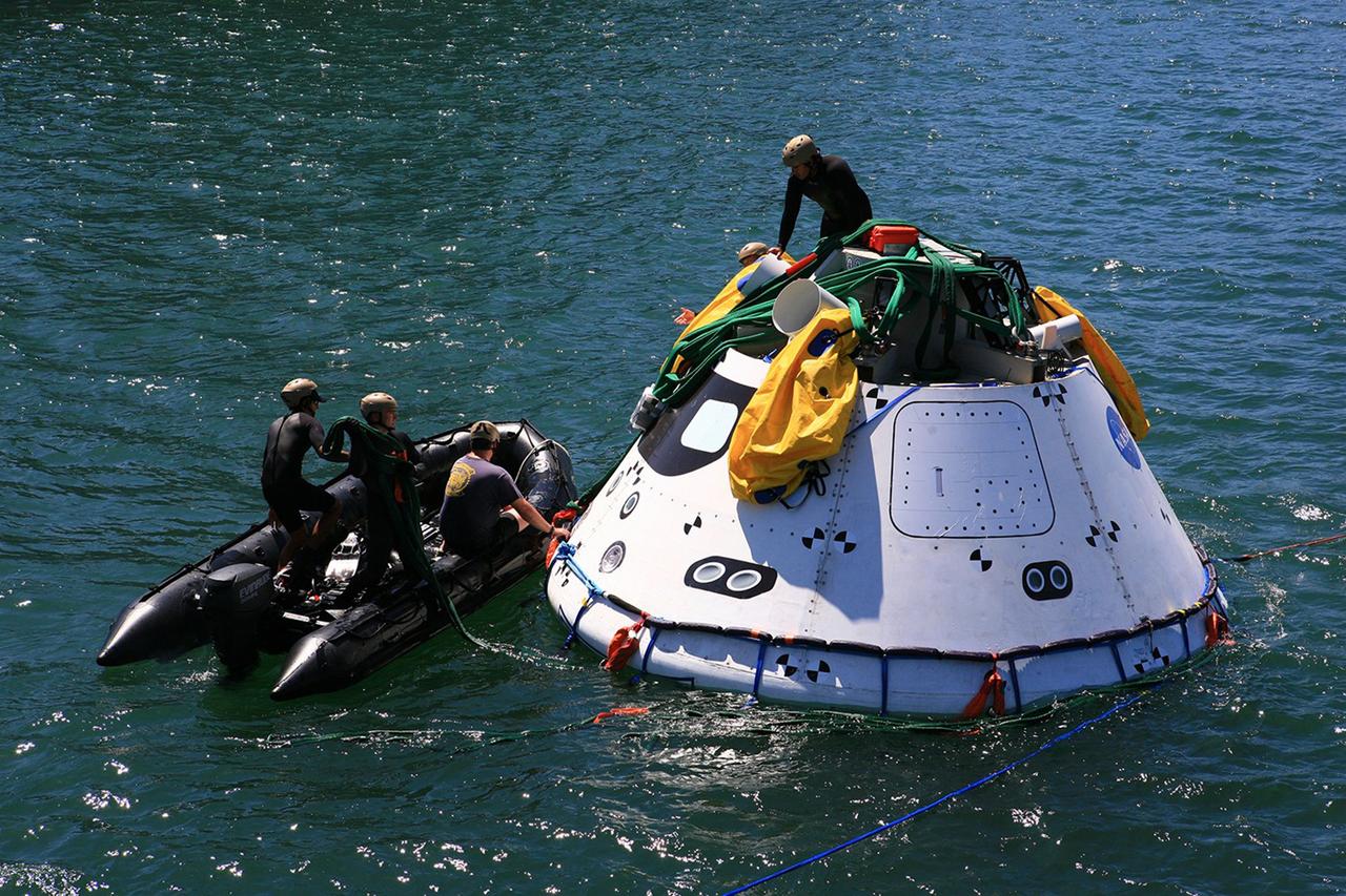 SAN DIEGO, Calif. – The Orion boilerplate test vehicle has been lowered into the water with a stationary crane from the USS Salvor, a safeguard-class rescue and salvage ship, during the first day of Underway Recovery Test 4A at Naval Base San Diego in California. U.S. Navy personnel in a Zodiac boat practice procedures to tether and retrieve the test vehicle. The ship will head out to sea for four days to test crew module crane recovery operations. NASA, Lockheed Martin and the U.S. Navy are conducting the test to prepare for recovery of the Orion crew module on its return from a deep space mission. The underway recovery test will allow the teams to demonstrate and evaluate the recovery processes, procedures, new hardware and personnel in open waters. The Ground Systems Development and Operations Program is conducting the underway recovery test. Orion is the exploration spacecraft designed to carry astronauts to destinations not yet explored by humans, including an asteroid and Mars. It will have emergency abort capability, sustain the crew during space travel and provide safe re-entry from deep space return velocities. The first unpiloted test flight of the Orion is scheduled to launch in December 2014 atop a United Launch Alliance Delta IV rocket and in 2018 on NASA’s Space Launch System rocket. For more information, visit http://www.nasa.gov/orion. Photo credit: Kim Shiflett