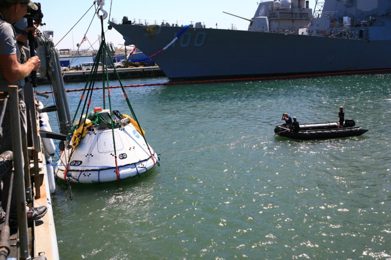 SAN DIEGO, Calif. – The Orion boilerplate test vehicle has been lowered into the water with a stationary crane from the USS Salvor, a safeguard-class rescue and salvage ship, during the first day of Underway Recovery Test 4A at Naval Base San Diego in California. U.S. Navy personnel in a Zodiac boat practice procedures to tether the test vehicle. The ship will head out to sea for four days to test crew module crane recovery operations. NASA, Lockheed Martin and the U.S. Navy are conducting the test to prepare for recovery of the Orion crew module on its return from a deep space mission. The underway recovery test will allow the teams to demonstrate and evaluate the recovery processes, procedures, new hardware and personnel in open waters. The Ground Systems Development and Operations Program is conducting the underway recovery test. Orion is the exploration spacecraft designed to carry astronauts to destinations not yet explored by humans, including an asteroid and Mars. It will have emergency abort capability, sustain the crew during space travel and provide safe re-entry from deep space return velocities. The first unpiloted test flight of the Orion is scheduled to launch in December 2014 atop a United Launch Alliance Delta IV rocket and in 2018 on NASA’s Space Launch System rocket. For more information, visit http://www.nasa.gov/orion. Photo credit: Kim Shiflett
