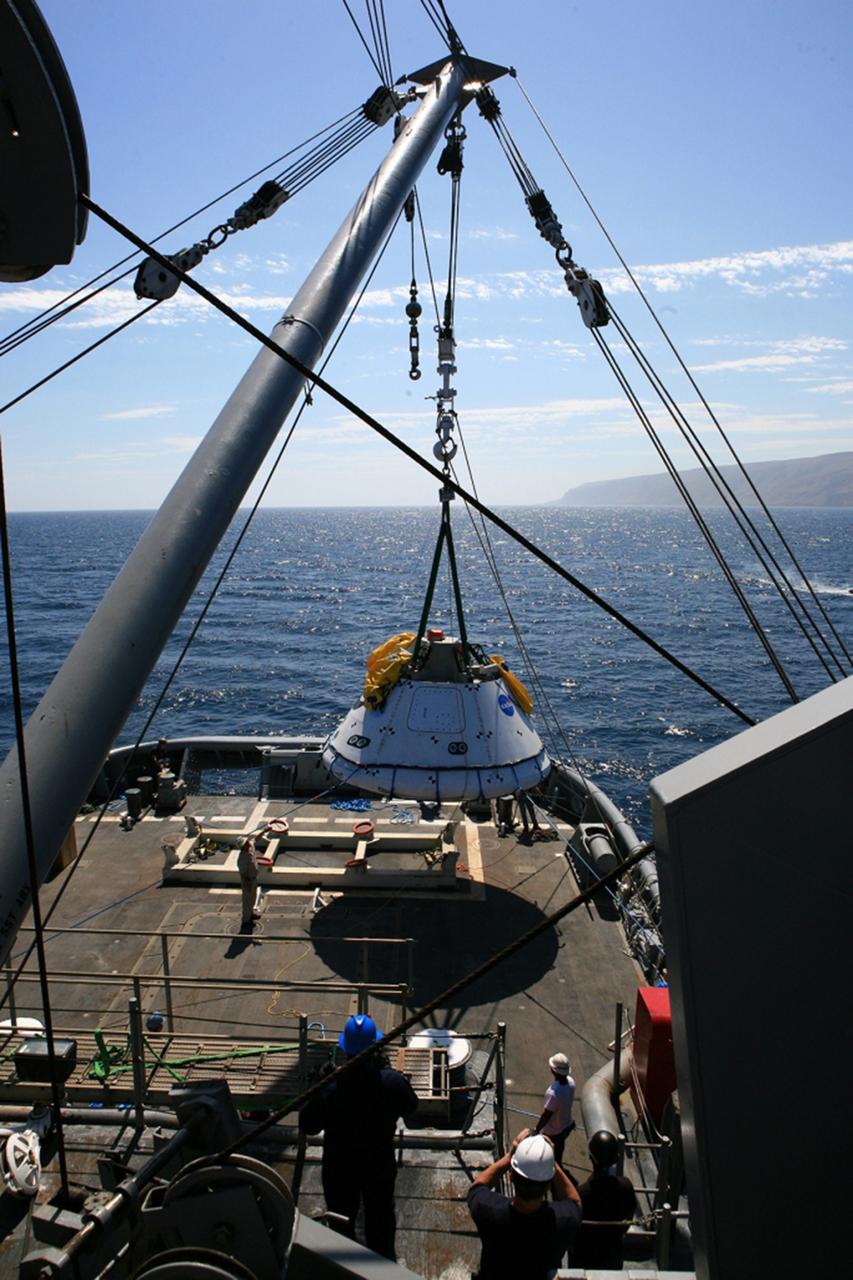 SAN DIEGO, Calif. – On board the USS Salvor, a safeguard-class rescue and salvage ship, U.S. Navy personnel monitor the progress as a stationary crane lifts the Orion boilerplate test vehicle during Underway Recovery Test 4A in the Pacific Ocean. The test vehicle will be lifted up and lowered into the water to test crew module crane recovery operations. NASA, Lockheed Martin and the U.S. Navy are conducting the test to prepare for recovery of the Orion crew module on its return from a deep space mission. The underway recovery test will allow the teams to demonstrate and evaluate the recovery processes, procedures, new hardware and personnel in open waters. The Ground Systems Development and Operations Program is conducting the underway recovery test. Orion is the exploration spacecraft designed to carry astronauts to destinations not yet explored by humans, including an asteroid and Mars. It will have emergency abort capability, sustain the crew during space travel and provide safe re-entry from deep space return velocities. The first unpiloted test flight of the Orion is scheduled to launch in December 2014 atop a United Launch Alliance Delta IV Heavy rocket and in 2018 on NASA’s Space Launch System rocket. For more information, visit http://www.nasa.gov/orion. Photo credit: Kim Shiflett