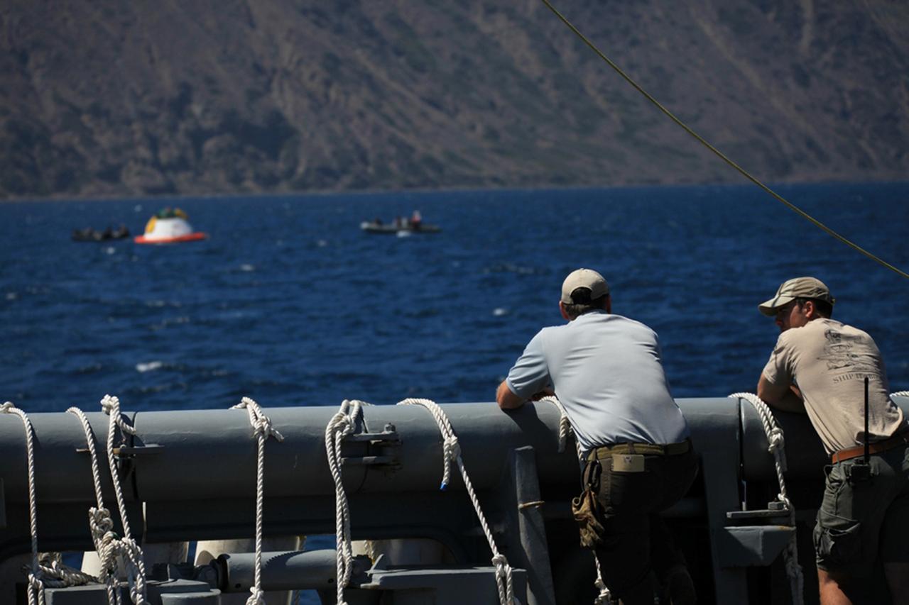 SAN DIEGO, Calif. – The Orion boilerplate test vehicle floats in the Pacific Ocean during Underway Recovery Test 4A. Orion was lowered into the water with a stationary crane from the USS Salvor, a safeguard-class rescue and salvage ship. Nearby, U.S. Navy personnel in a Zodiac boat and rigid hull inflatable boat prepare to practice procedures to tether and retrieve the test vehicle. NASA, Lockheed Martin and the U.S. Navy are conducting crane recovery tests to prepare for recovery of the Orion crew module on its return from a deep space mission. The underway recovery test will allow the teams to demonstrate and evaluate the recovery processes, procedures, new hardware and personnel in open waters. The Ground Systems Development and Operations Program is conducting the underway recovery test. Orion is the exploration spacecraft designed to carry astronauts to destinations not yet explored by humans, including an asteroid and Mars. It will have emergency abort capability, sustain the crew during space travel and provide safe re-entry from deep space return velocities. The first unpiloted test flight of the Orion is scheduled to launch in December 2014 atop a United Launch Alliance Delta IV Heavy rocket and in 2018 on NASA’s Space Launch System rocket. For more information, visit http://www.nasa.gov/orion. Photo credit: Kim Shiflett