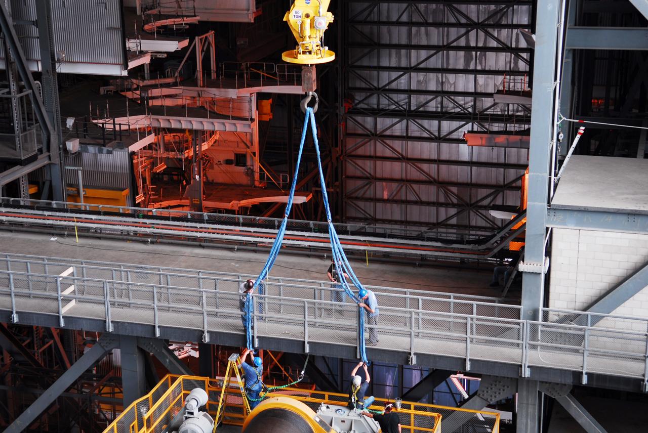 CAPE CANAVERAL, Fla. – Inside the Vehicle Assembly Building, or VAB, at NASA's Kennedy Space Center in Florida, workers have secured a crane to a portion of the catwalk on the east side of Level 16. The catwalk will be removed to allow room for the removal of the 175-ton crane that is situated above the transfer aisle. The crane will be lowered to the floor to perform upgrades to its 45-year-old controls in order to improve reliability, precision and safety. The Ground Systems Development and Operations Program is overseeing upgrades and modifications to the VAB. The crane will be upgraded so that it can support lifting needs for NASA and other exploration vehicles, including the agency's Space Launch System and Orion spacecraft. Photo credit: NASA/Jim Grossmann