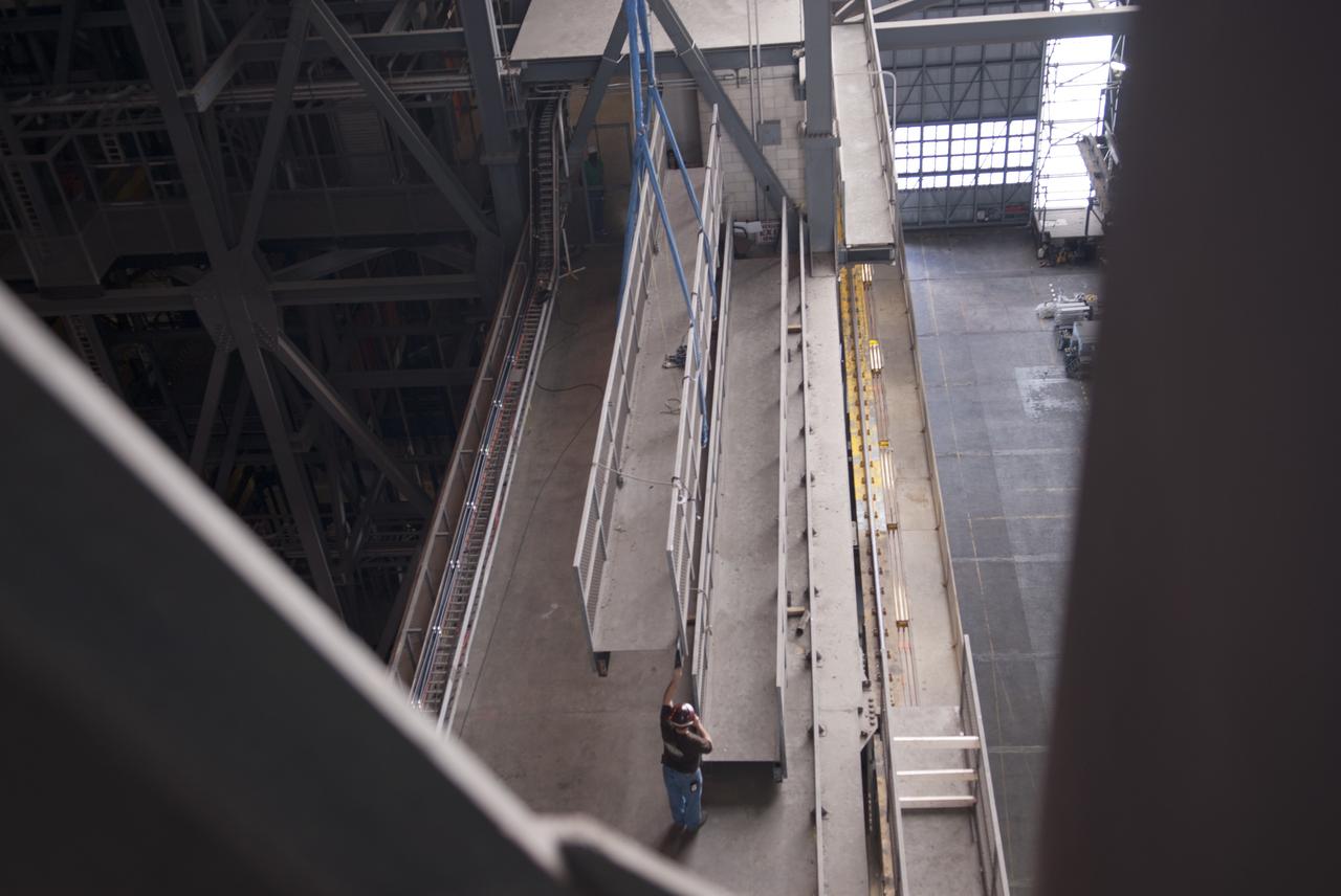 CAPE CANAVERAL, Fla. – Inside the Vehicle Assembly Building, or VAB, at NASA's Kennedy Space Center in Florida, portions of the catwalks on the east and west sides of Level 16 have been removed by crane and are being placed on the east side for storage. The catwalks were removed to allow room for the removal of the 175-ton crane that is situated above the transfer aisle. The crane will be lowered to the floor to perform upgrades to its 45-year-old controls in order to improve reliability, precision and safety. The Ground Systems Development and Operations Program is overseeing upgrades and modifications to the VAB. The crane will be upgraded so that it can support lifting needs for NASA and other exploration vehicles, including the agency's Space Launch System and Orion spacecraft. Photo credit: NASA/Jim Grossmann