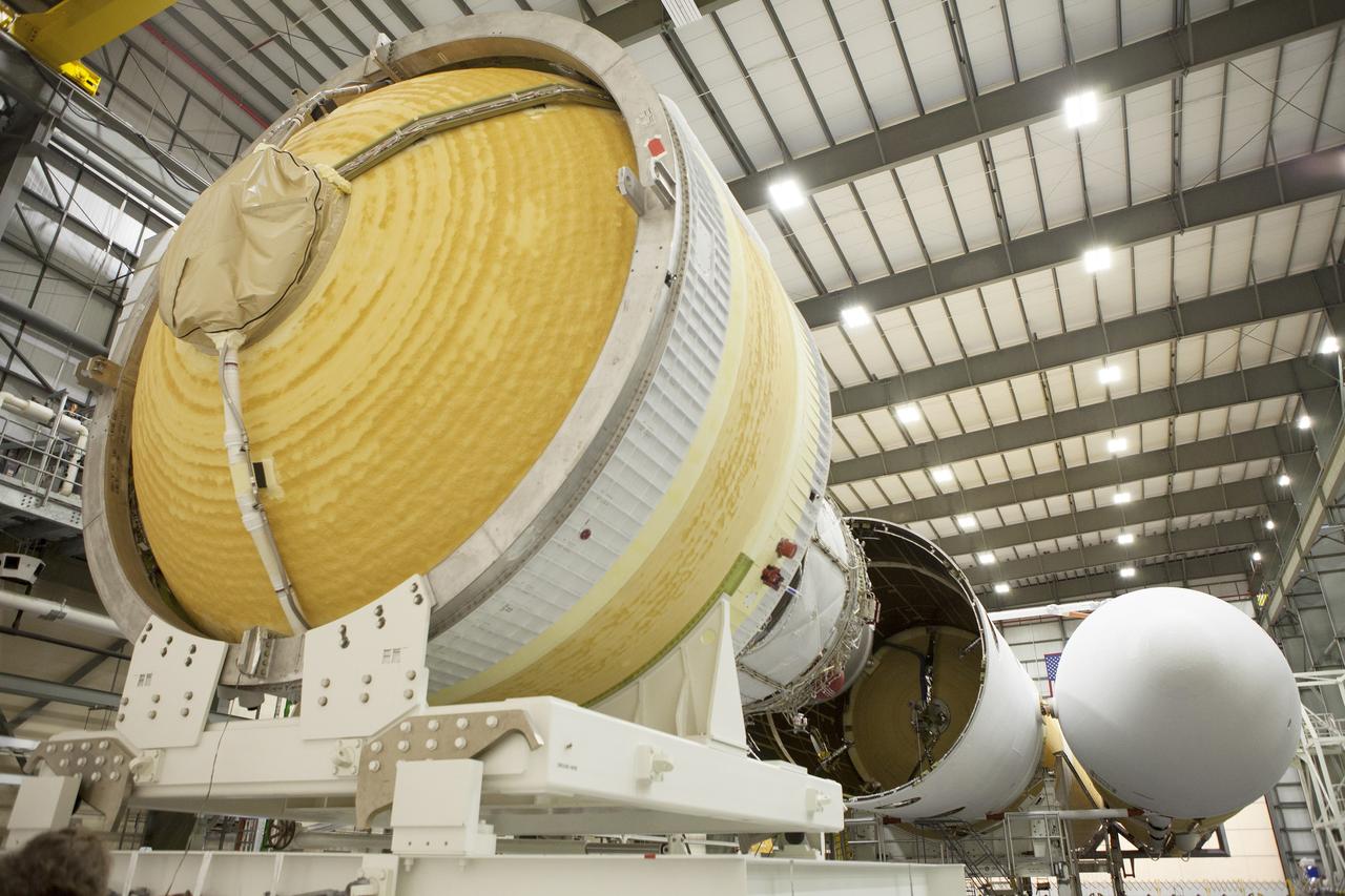 CAPE CANAVERAL, Fla. – Inside the Horizontal Integration Facility at Space Launch Complex 37 at Cape Canaveral Air Force Station in Florida, preparations are underway to mate the second stage of a Delta IV Heavy rocket to the central core booster of the three booster stages for the unpiloted Exploration Flight Test-1, or EFT-1. During the mission, Orion will travel farther into space than any human spacecraft has gone in more than 40 years. The data gathered during the flight will influence design decisions, validate existing computer models and innovative new approaches to space systems development, as well as reduce overall mission risks and costs for later Orion flights. Liftoff of Orion on the first flight test is planned for December 2014. Photo credit: NASA/Daniel Casper