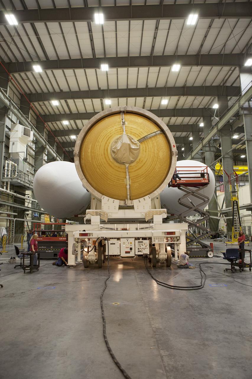 CAPE CANAVERAL, Fla. – Inside the Horizontal Integration Facility at Space Launch Complex 37 at Cape Canaveral Air Force Station in Florida, the second stage of the United Launch Alliance Delta IV Heavy rocket has been mated to the core booster of the three booster stages for the unpiloted Exploration Flight Test-1, or EFT-1. During the mission, Orion will travel farther into space than any human spacecraft has gone in more than 40 years. The data gathered during the flight will influence design decisions, validate existing computer models and innovative new approaches to space systems development, as well as reduce overall mission risks and costs for later Orion flights. Liftoff of Orion on the first flight test is planned for December 2014. Photo credit: NASA/Daniel Casper