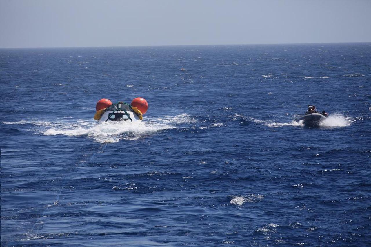 SAN DIEGO, Calif. – The Orion boilerplate test vehicle floats in the Pacific Ocean during the third day of Underway Recovery Test 4A. Orion was lowered into the water from the USS Salvor, a safeguard-class rescue and salvage ship, using a stationary crane. Tether lines were attached to the test vehicle from the ship for a towing test. Navy divers in a Zodiac boat practice recovery procedures and monitor Orion. NASA, Lockheed Martin and the U.S. Navy are conducting the test to prepare for recovery of the Orion crew module on its return from a deep space mission. The underway recovery test allows the teams to demonstrate and evaluate the recovery processes, procedures, new hardware and personnel in open waters. The Ground Systems Development and Operations Program is conducting the underway recovery test. Orion is the exploration spacecraft designed to carry astronauts to destinations not yet explored by humans, including an asteroid and Mars. It will have emergency abort capability, sustain the crew during space travel and provide safe re-entry from deep space return velocities. The first unpiloted test flight of the Orion is scheduled to launch in December 2014 atop a United Launch Alliance Delta IV Heavy rocket and in 2018 on NASA’s Space Launch System rocket. For more information, visit http://www.nasa.gov/orion. Photo credit: NASA/Kim Shiflett