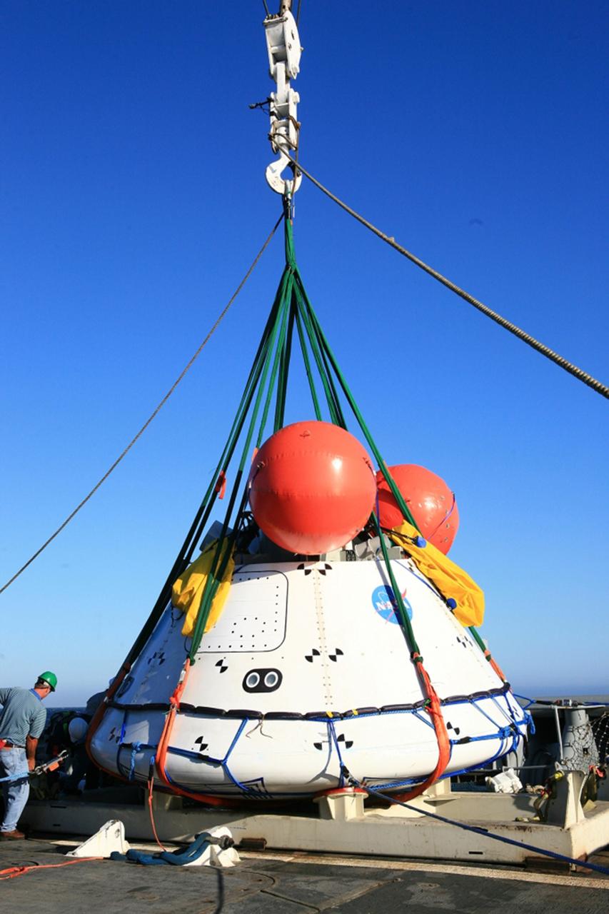 SAN DIEGO, Calif. – On the third day of Underway Recovery Test 4A in the Pacific Ocean, the Orion boilerplate test vehicle has been lifted out of the water and placed in a cradle in the USS Salvor, a safeguard-class rescue and salvage ship, using a stationary crane. NASA, Lockheed Martin and the U.S. Navy are testing crane recovery operations to prepare for recovery of the Orion crew module on its return from a deep space mission. The underway recovery test allows the teams to demonstrate and evaluate the recovery processes, procedures, new hardware and personnel in open waters. The Ground Systems Development and Operations Program is conducting the underway recovery test. Orion is the exploration spacecraft designed to carry astronauts to destinations not yet explored by humans, including an asteroid and Mars. It will have emergency abort capability, sustain the crew during space travel and provide safe re-entry from deep space return velocities. The first unpiloted test flight of the Orion is scheduled to launch in December 2014 atop a United Launch Alliance Delta IV Heavy rocket and in 2018 on NASA’s Space Launch System rocket. For more information, visit http://www.nasa.gov/orion. Photo credit: NASA/Kim Shiflett