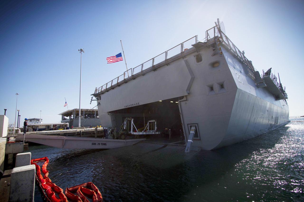 SAN DIEGO, Calif. – The USS Anchorage is docked at Naval Base San Diego during loading operations in its well deck for Orion Underway Recovery Test 3. The ship will head out to sea, off the coast of San Diego, in search of conditions to support test needs for a full dress rehearsal of recovery operations. NASA, Lockheed Martin and U.S. Navy personnel will conduct tests in the Pacific Ocean to prepare for recovery of the Orion crew module on its return from a deep space mission. The test will allow the teams to demonstrate and evaluate the recovery processes, procedures, new hardware and personnel in open waters.    The Ground Systems Development and Operations Program is conducting the underway recovery tests. Orion is the exploration spacecraft designed to carry astronauts to destinations not yet explored by humans, including an asteroid and Mars. It will have emergency abort capability, sustain the crew during space travel and provide safe re-entry from deep space return velocities. The first unpiloted test flight of Orion is scheduled to launch in 2014 atop a United Launch Alliance Delta IV Heavy rocket and in 2018 on NASA’s Space Launch System rocket. For more information, visit http://www.nasa.gov/orion. Photo credit: NASA/Cory Huston